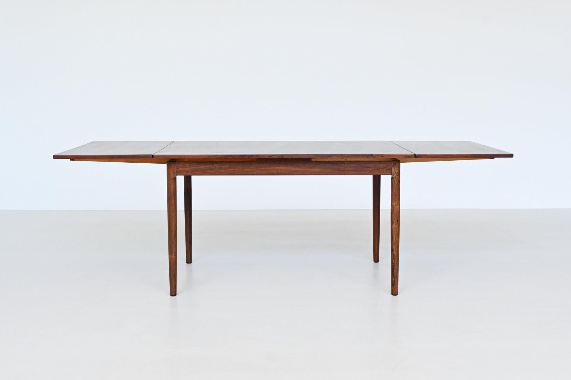 Magnifique table de salle à manger à rallonge de forme ovale conçue et fabriquée par Randers Mobelfabrik, Danemark 1960. Cette table de bonne facture est fabriquée en bois de rose chaud et magnifiquement veiné. Les pieds fuselés sont en palissandre