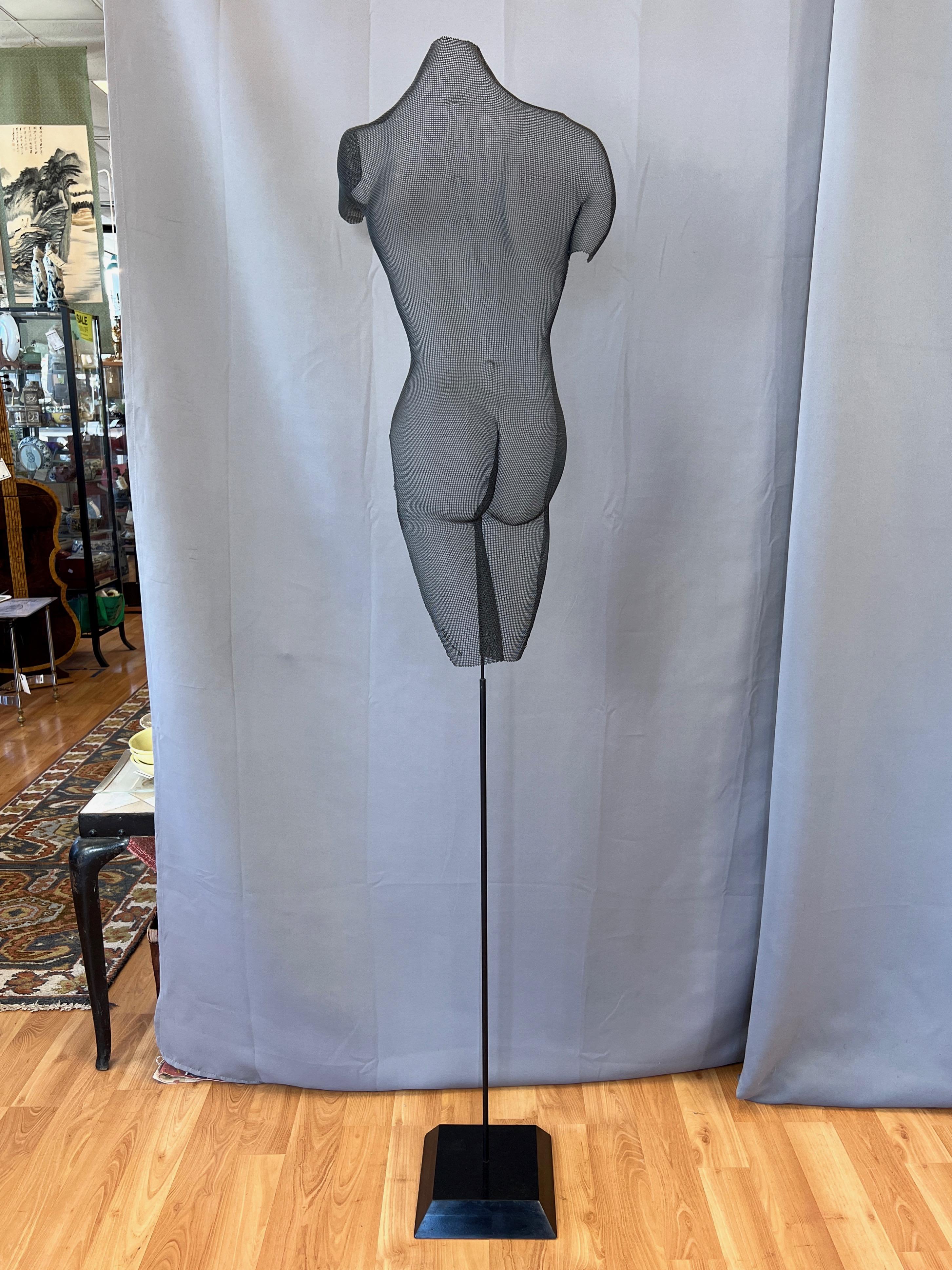An entrancing 1998 “Melanie” wire mesh screen figural shadow sculpture on black wood base by American artist Randy Cooper.

Extremely well-executed nearly life-size feminine form is hand-shaped from a single piece of fine-gauge Czechoslovakian wire