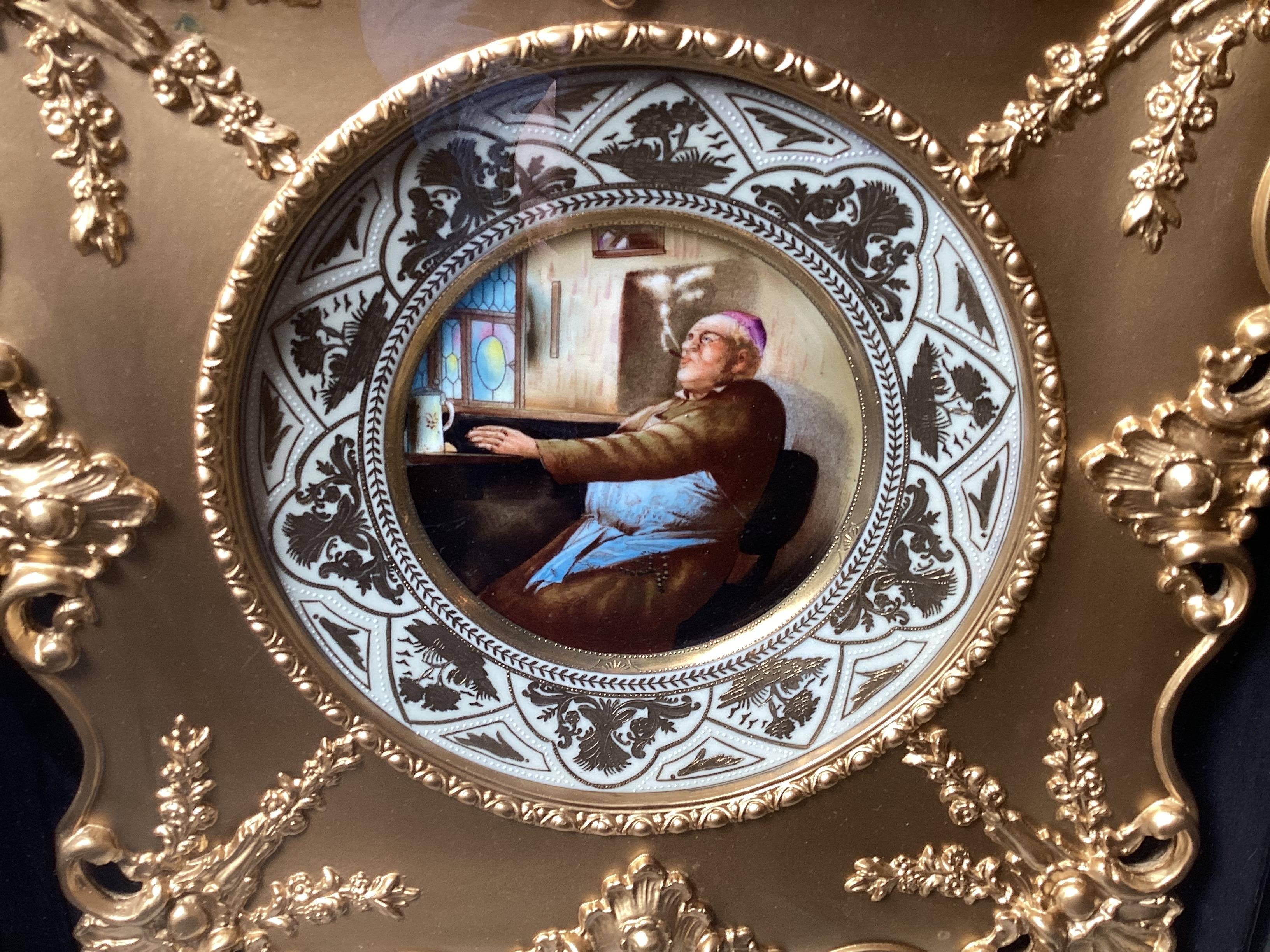 A hand painted porcelain cabinet plate with elaborate hand decorated raised gilt border, the central figure of a bishop.  The porcelain is 19th Century German or Austrian, with a beautiful elaborate gilt wood frame then mounted in an ebonized wood