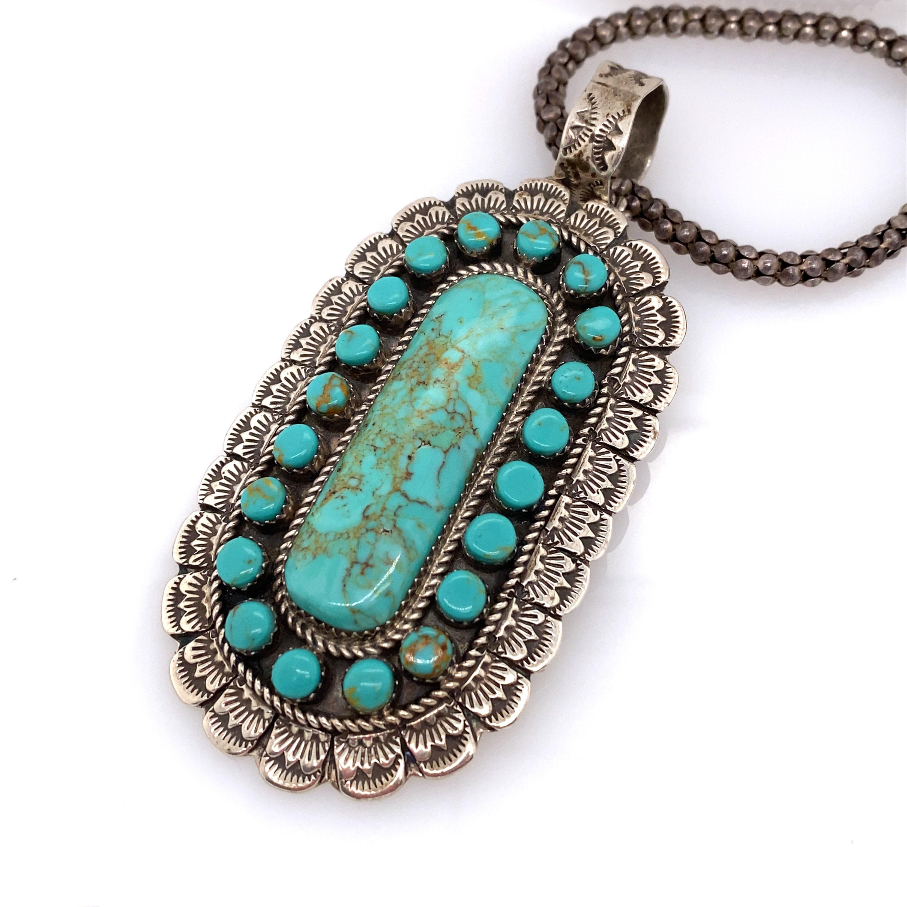 This intricate pendant and chain by Zuni artist Randy Mahooty features lush blue turquoise.

Metal Type: Sterling silver 
Weight: 53.3g
Dimensions: 30 in chain, 3.5in pendant height