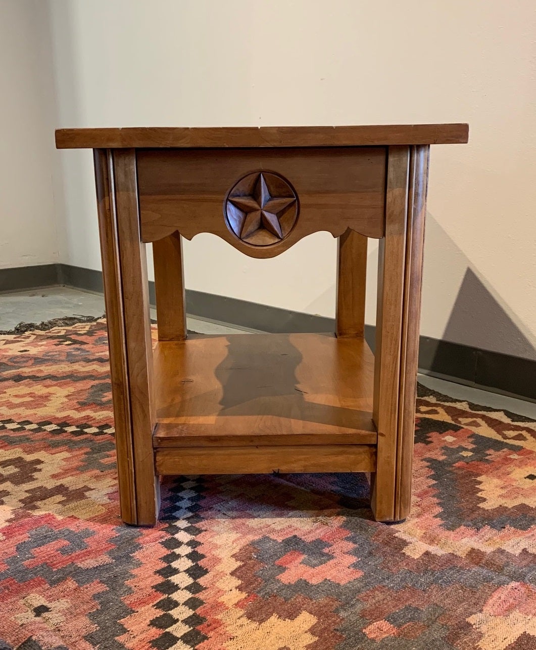 The Ranger End Table is the perfect compliment to a Country or Southwestern Decorated Room. Hand carved star on drawer front. Made in Alder with Cognac finish.

Showroom floor model that shows some use.