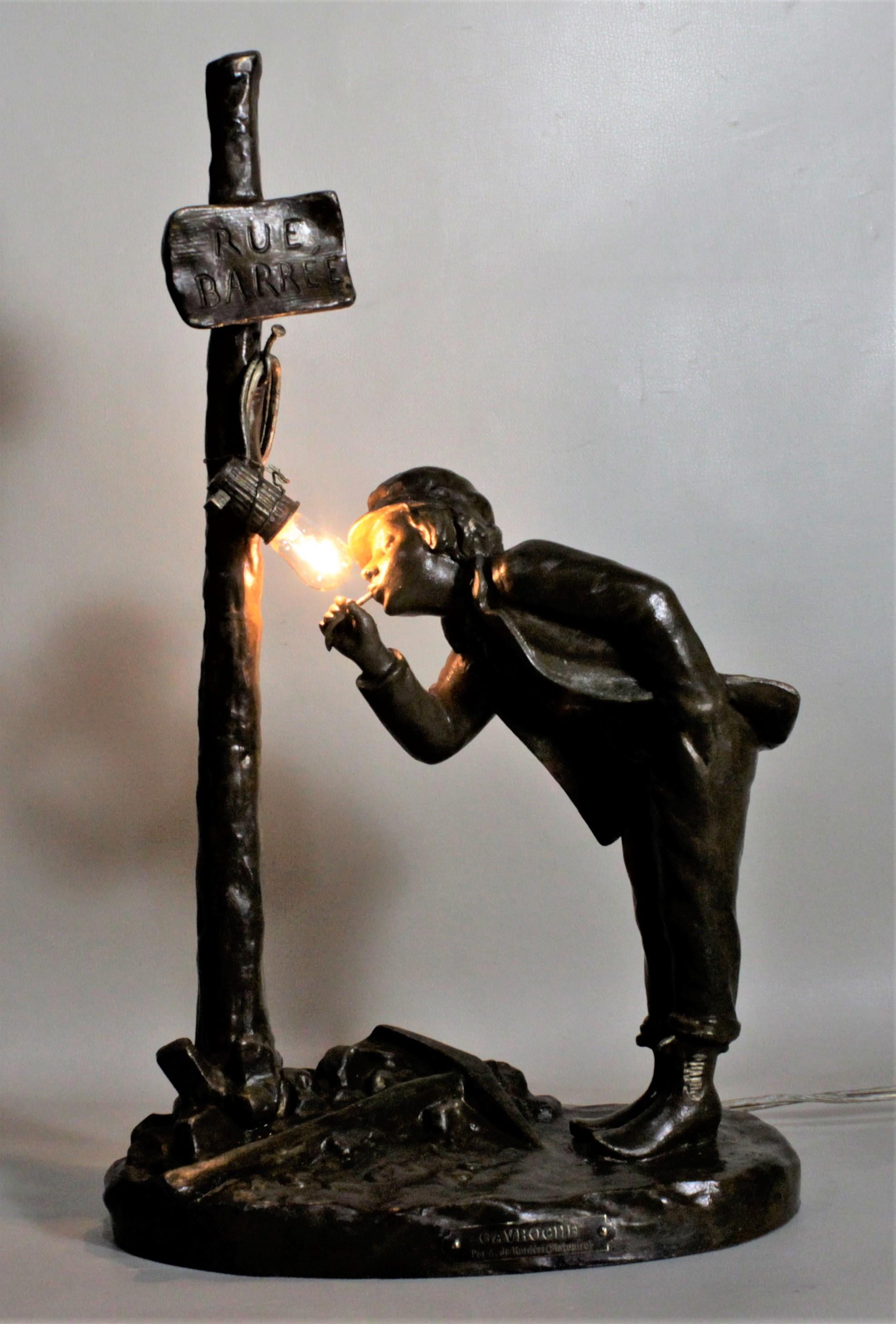 This antique patinated bronze cast spelter table lamp was designed by A. Renieri and made in France in circa 1890 in the Victorian style. The casting is quite detailed and is entitled 