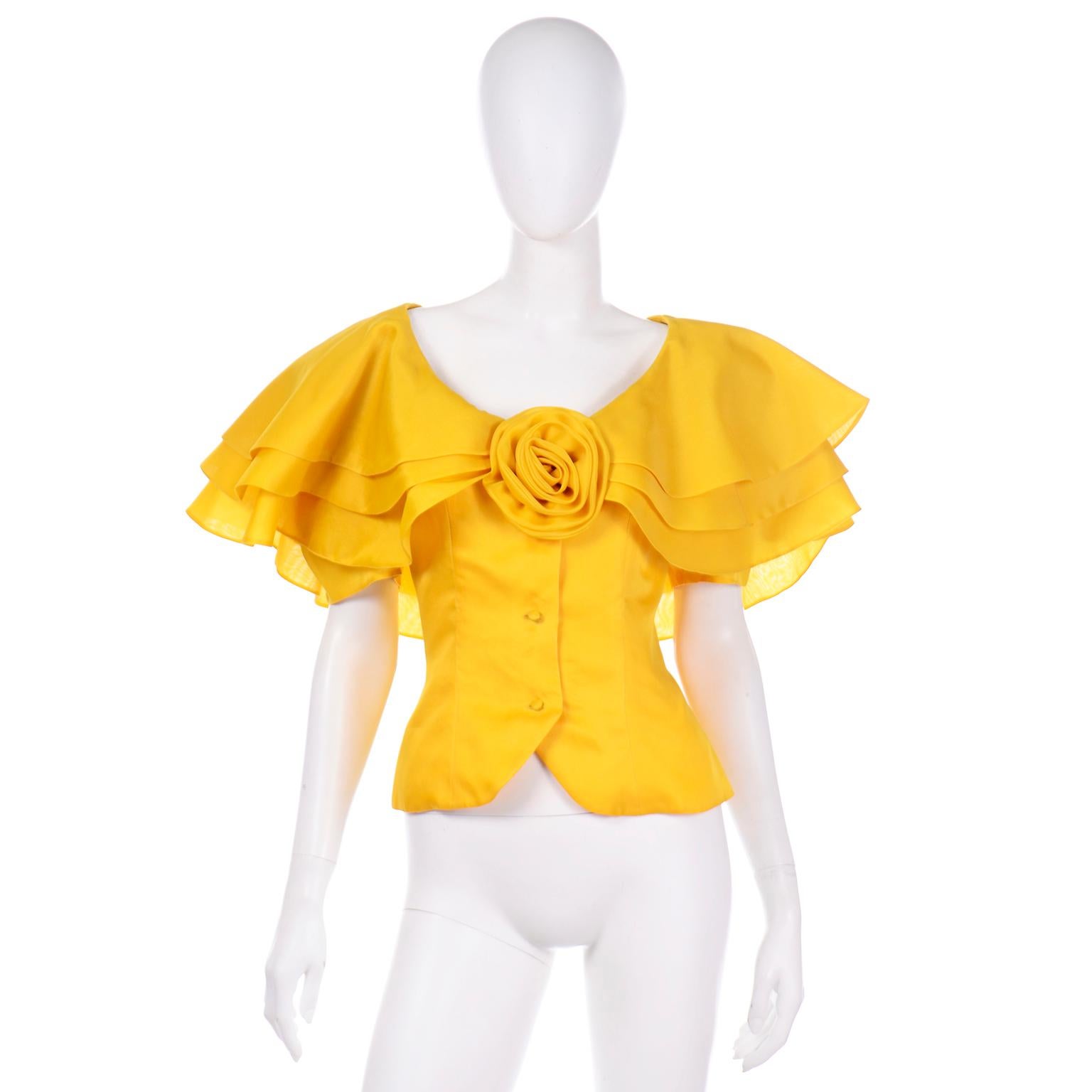 This incredible vintage Raoul Arango Saks Fifth Avenue Yellow Silk Floral Ruffled Blouse still has its original Saks Fifth Avenue tag for $1095 attached. The top is in a marigold yellow silk organza and the sleeves are made of layers of ruffles. We