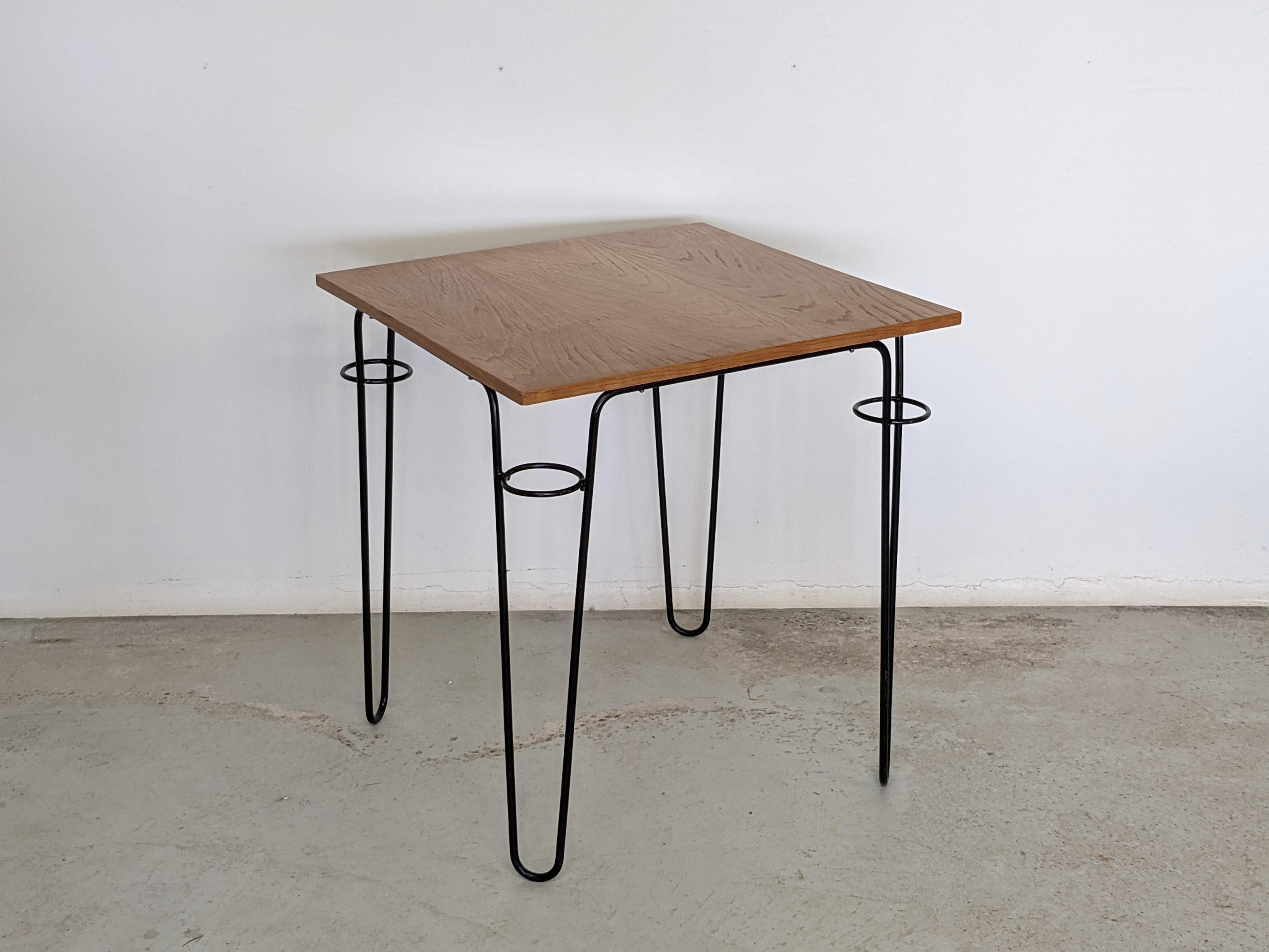 Square table by french designer Raoul Guys.
Black lacquered metal feet with an ash wood veneered top.
Made in France in the 1950s.

Literature: 