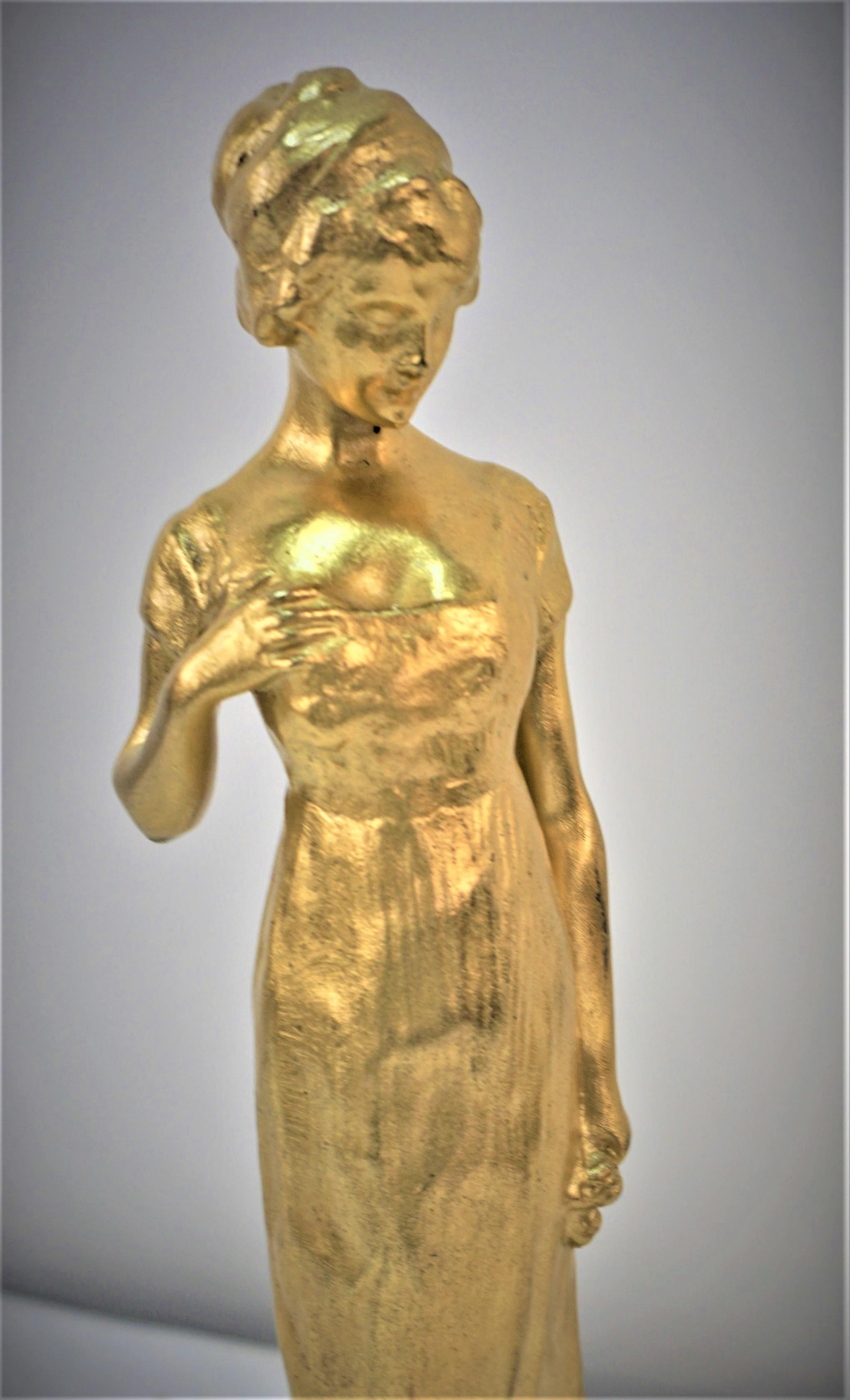 French art nouveau woman standing in gilt bronze with flower in her hand. 
Signed RAOUL LARCHE with Siot Paris foundry mark.