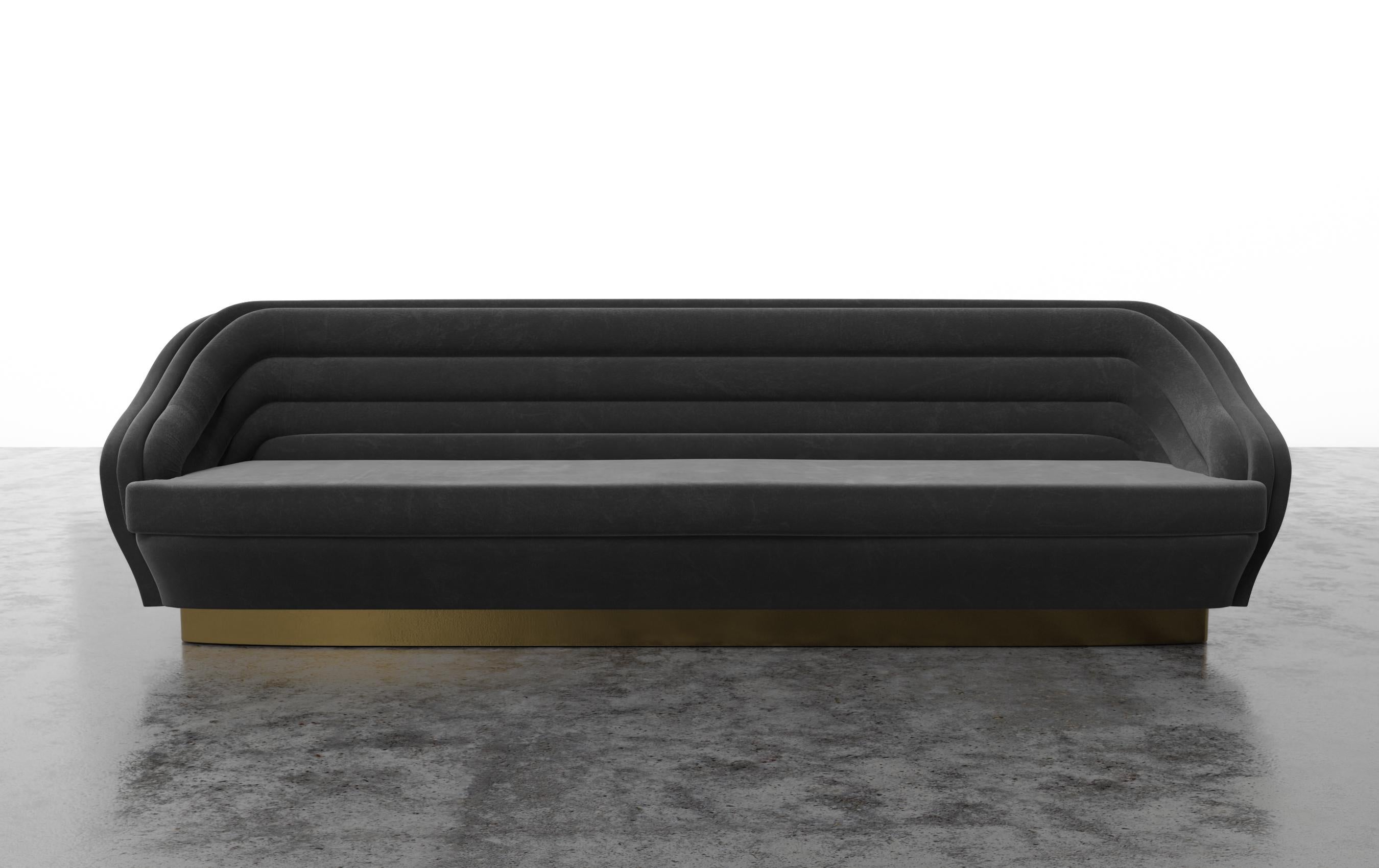 RAOUL SOFA - Modern Channeled Sofa on Brass Plinth Base in COM

The Raoul sofa sounds like a luxurious and stylish piece of furniture that draws inspiration from Jean Paul Gaultier Haute Couture. The horizontal velvet channels and brushed brass