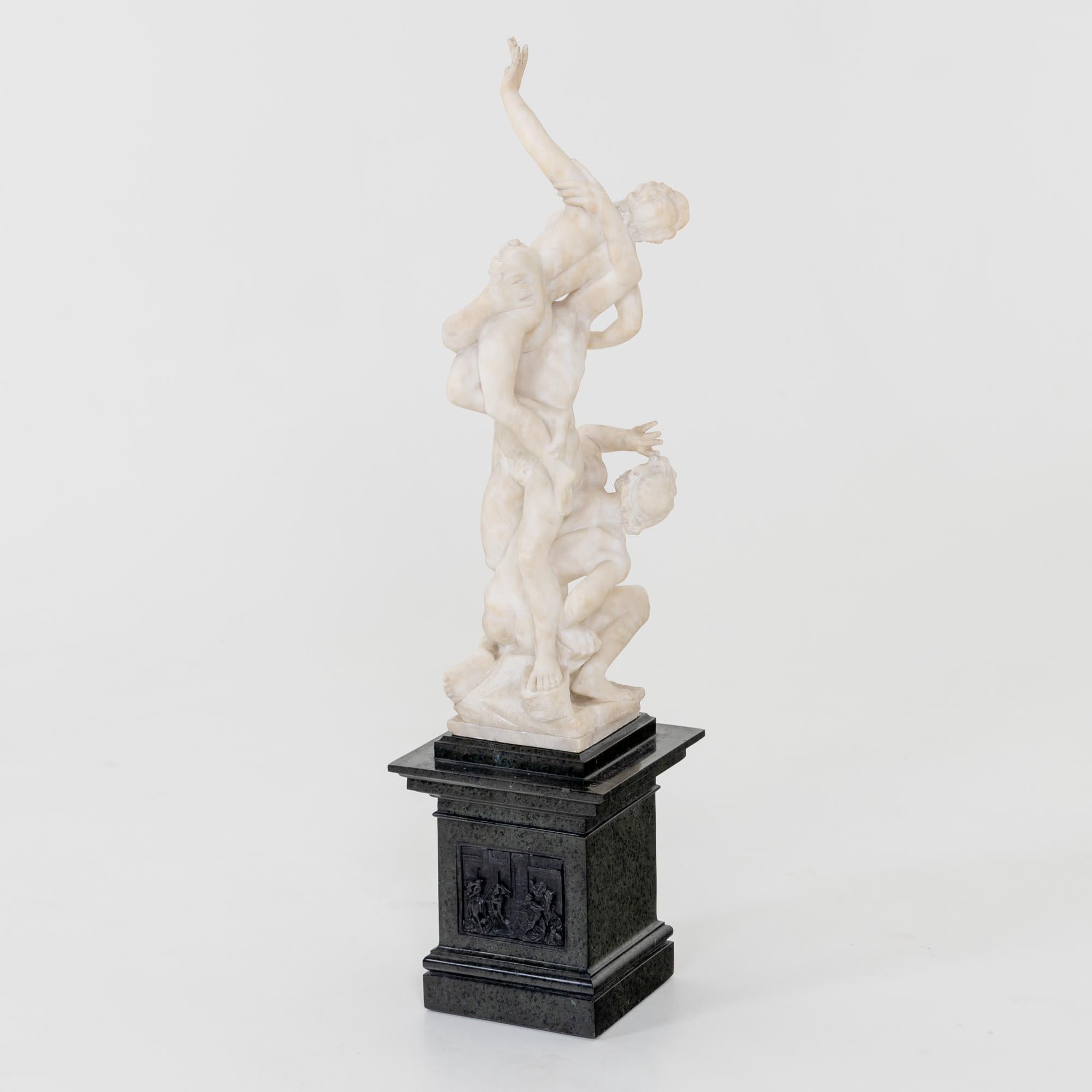 Marble sculpture based on the famous original by Giambologna (Jean de Bologne), the Rape of the Sabine Women, from 1579. This version is from the 19th century and mounted on a square pedestal of dark marble in the Renaissance style.