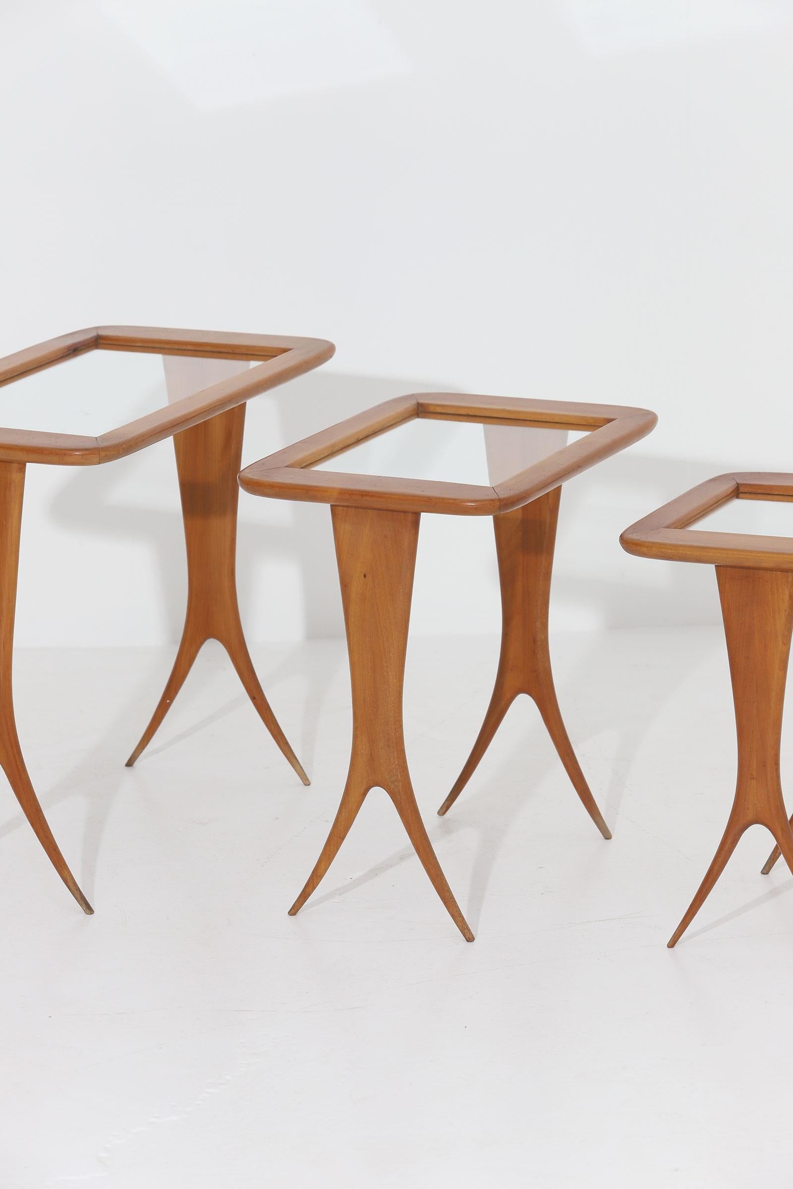 Walnut nesting tables, by Raphael, France, 1950s.

Set of three highly decorative nesting tables from the 1950s. An Elegant and sculptural set in a warm colored wood, each with a built- in glas top. The tables are light in weight, tight and