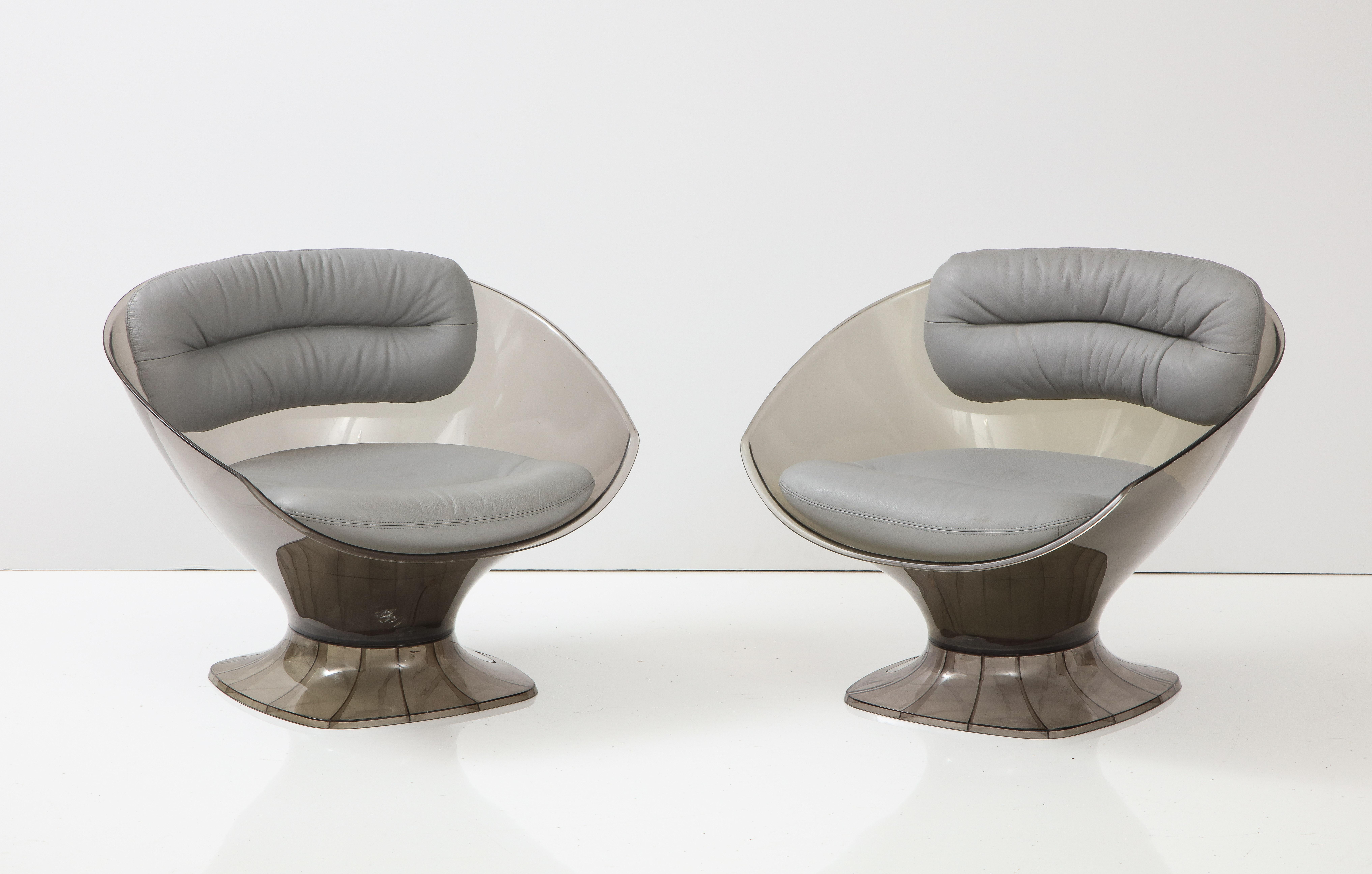 Modernist injection mold smokey grey acrylic chairs with grey leather cushions. Made in Germany for Raphael France, c60s.