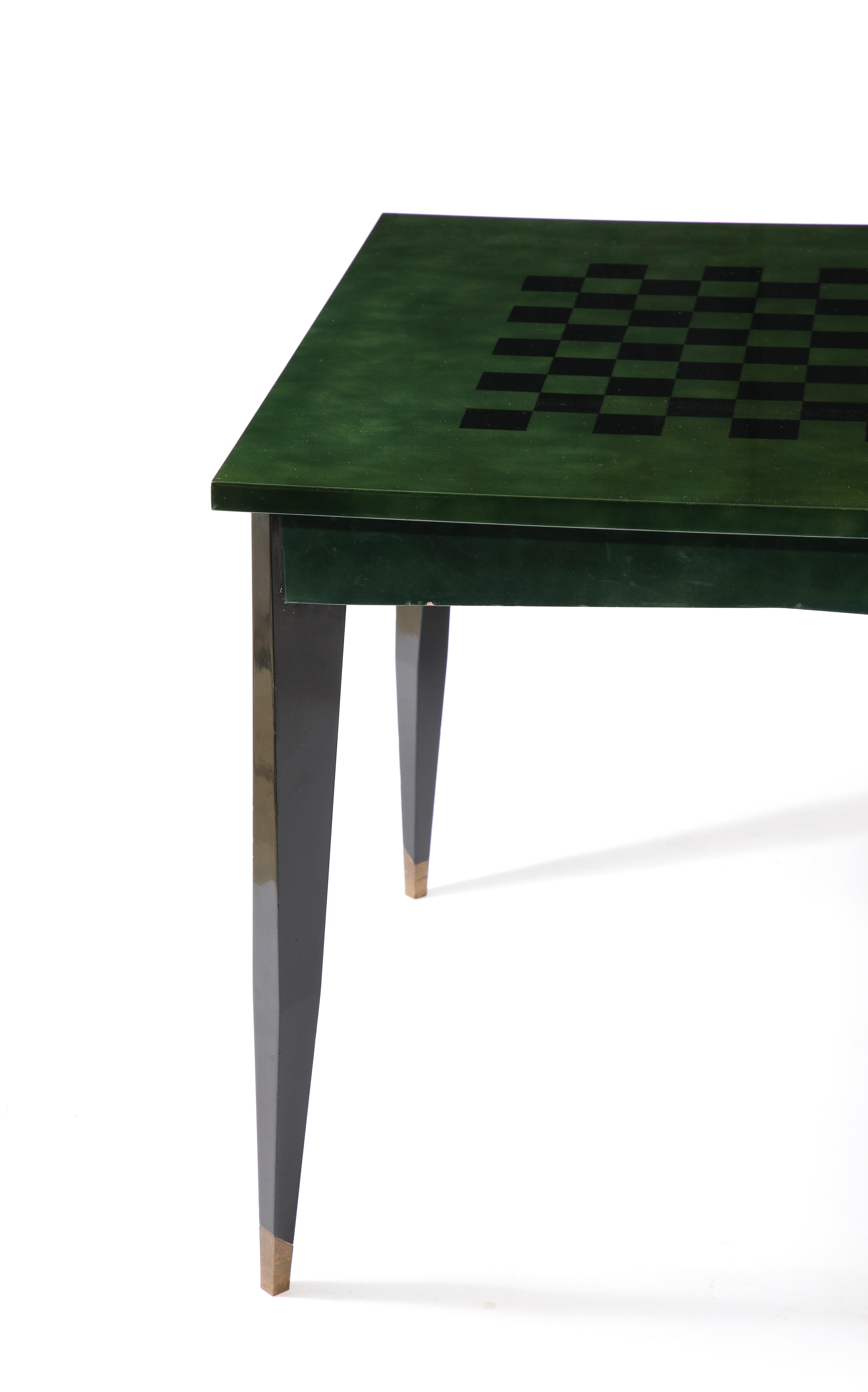 Exceptional game table by Raphael, the legs are black lacquered with brass sabots, and the top is done in Raphael's signature Beka green ombré lacquer with the chessboard design embedded in the middle. The sides have pull-out trays to hold a drink