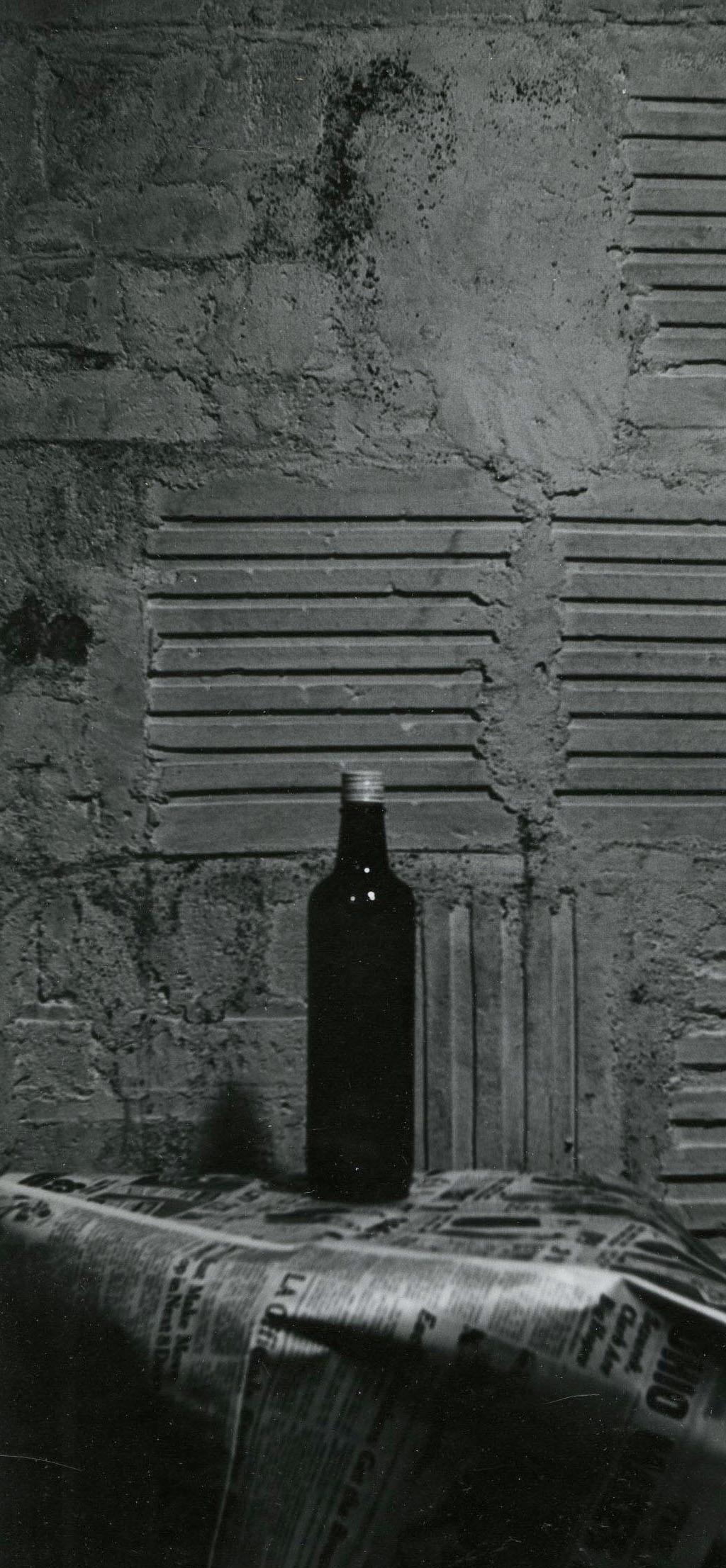 Still Life with bottle and newspaper - American Modern Photograph by Raphael Gleitsman