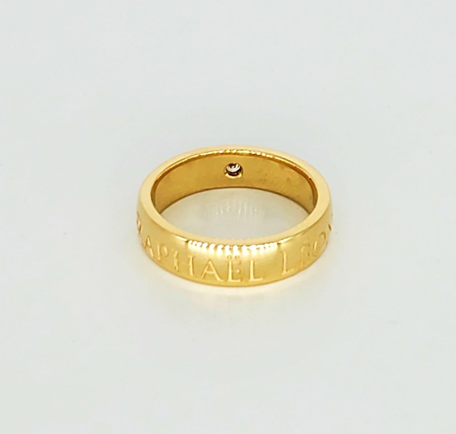 Raphael Leon 0.05 Carat Diamond 14k Gold Band Ring. The ring is # 0002/1000 by famous jewelry designer Raphael Leon and is a size 7.5 weighting 6.7 grams.