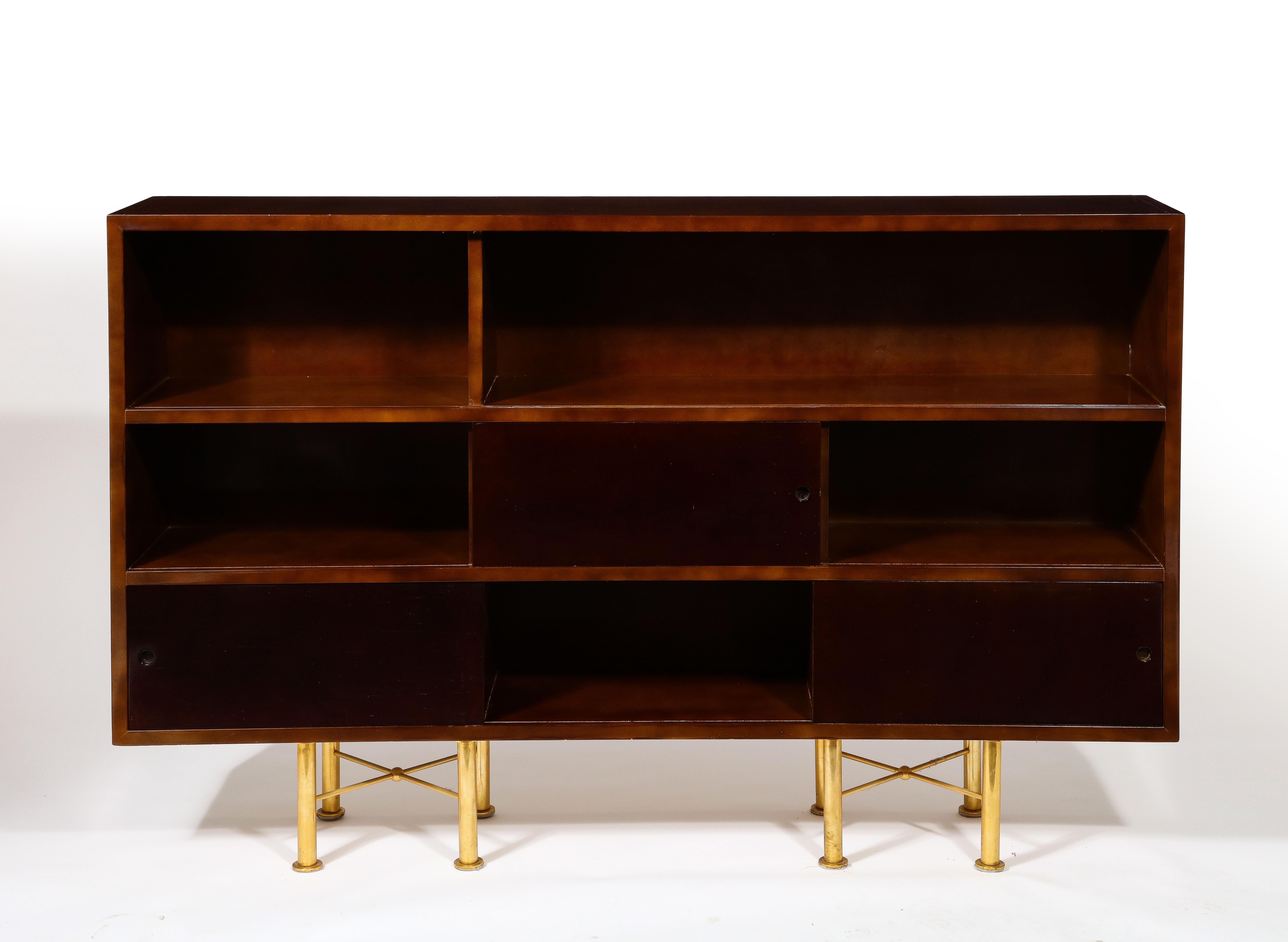 Exceptional Raphael bookcase in his signature Béka lacquer finish, a technique he championed that gave the lacquer an ombré appearance; it rests on gilt bronze legs, Signed on a brass plaque in the back. The unit can also be hung to the wall -in