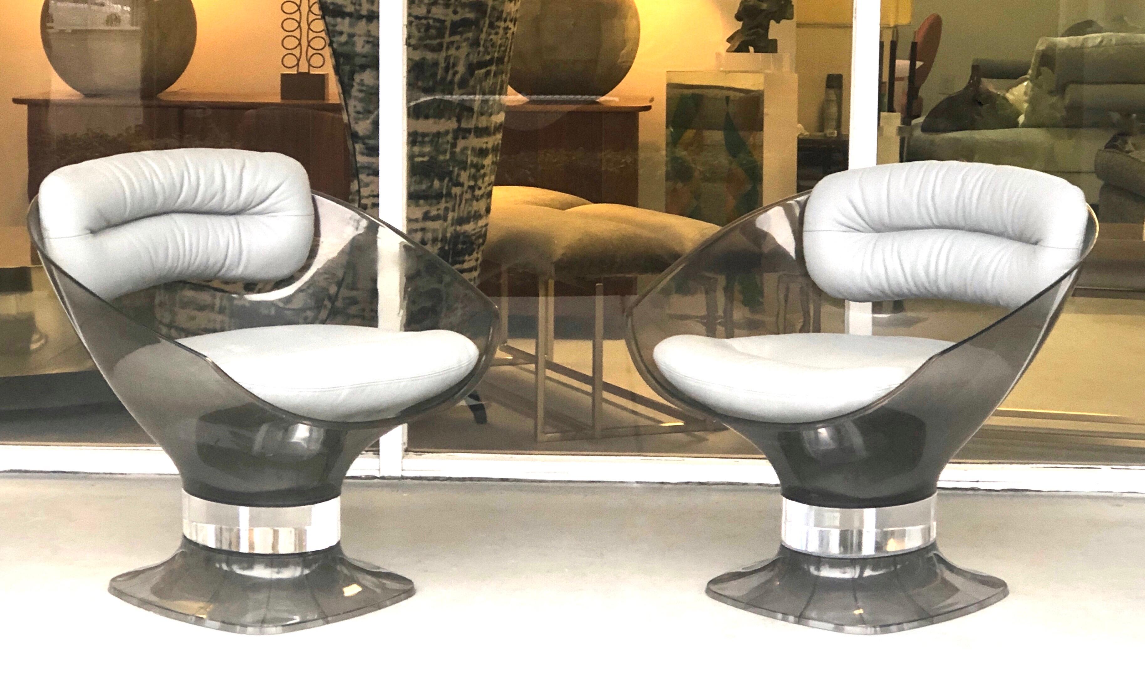 A pair of 1970s chairs. Bronze tone acrylic frames and light gray leather upholstery.