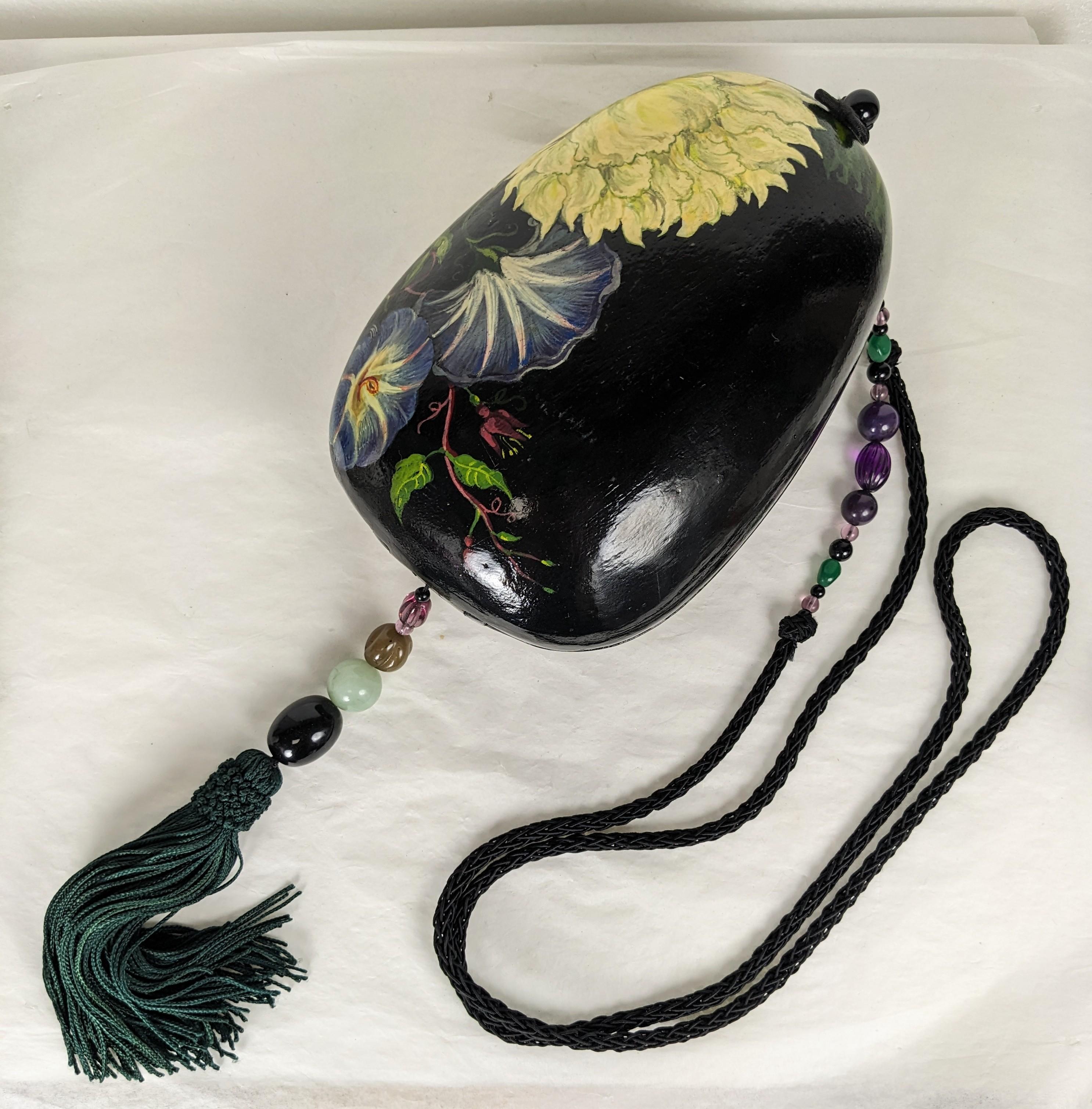 Rafael Sanchez Hand Painted Minaudiere from the 1970's. Hand painted on egg shaped wood base with flowers on black ground with silk tassels and matching cord. Asian overtones with the braided silk cording mixed with glass and semi precious stone