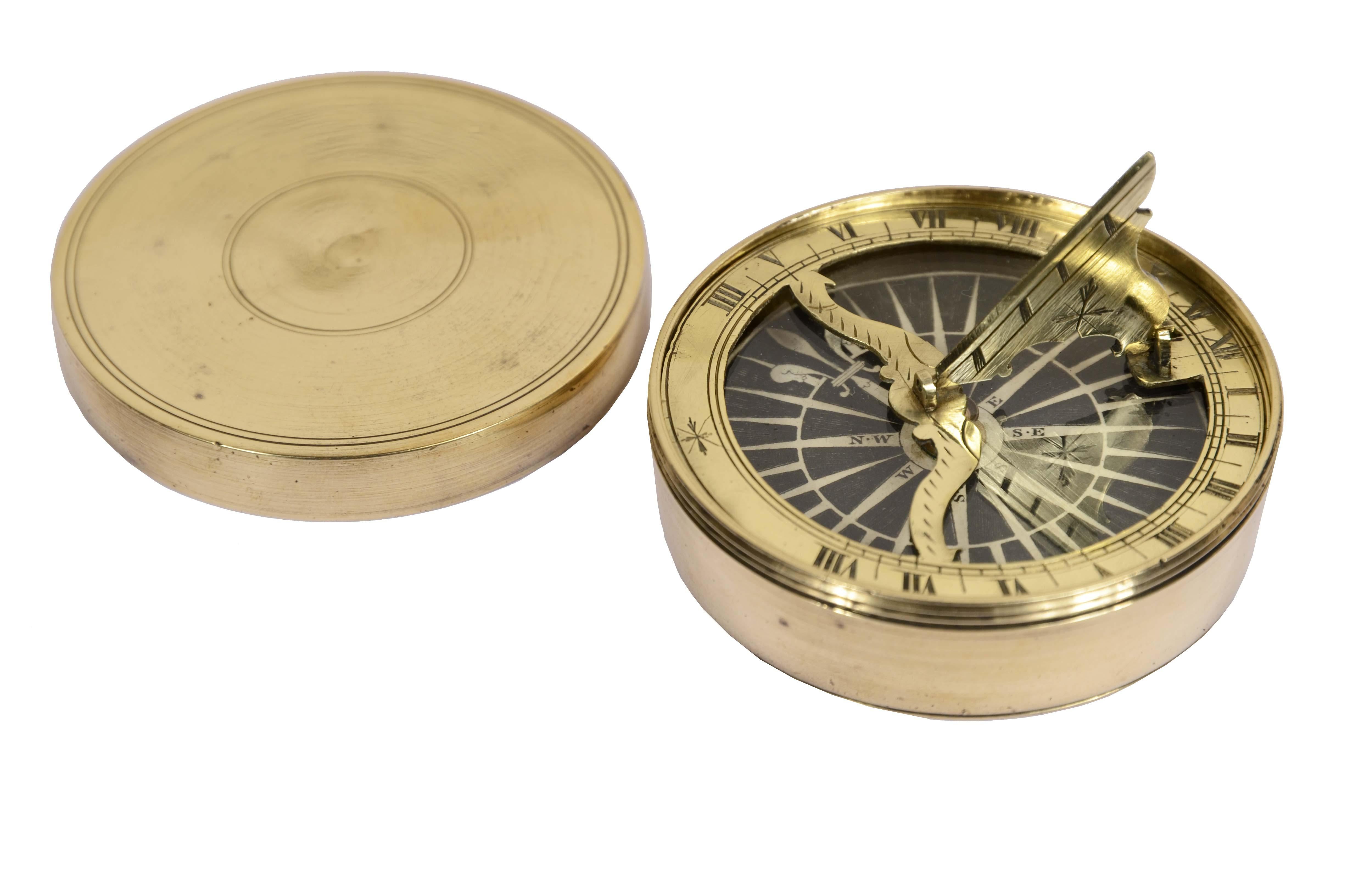 Rare nautical compass and sundial together, English manufacture from the first half of the 19th century, housed in a turned box  brass complete with screw-on cover. Rose to sixteen  winds on engraving paper on copper plate, brass sundial with