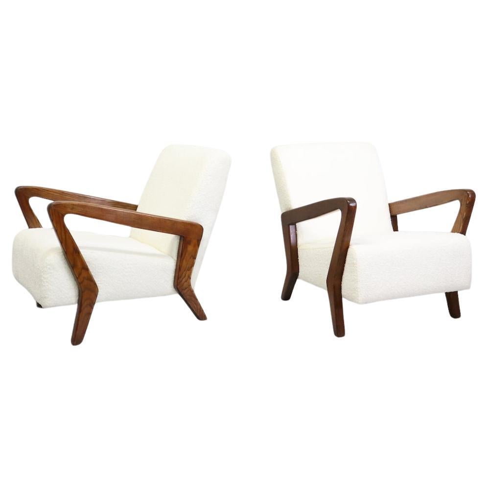 Rare and sophisticated pair of armchairs  mid-century Italian from an important villa in Bologna. 
Designed by Gio Ponti, boucle  and wood, 1950s  The wood was polished by our restorers, who covered the chairs in white boucle.