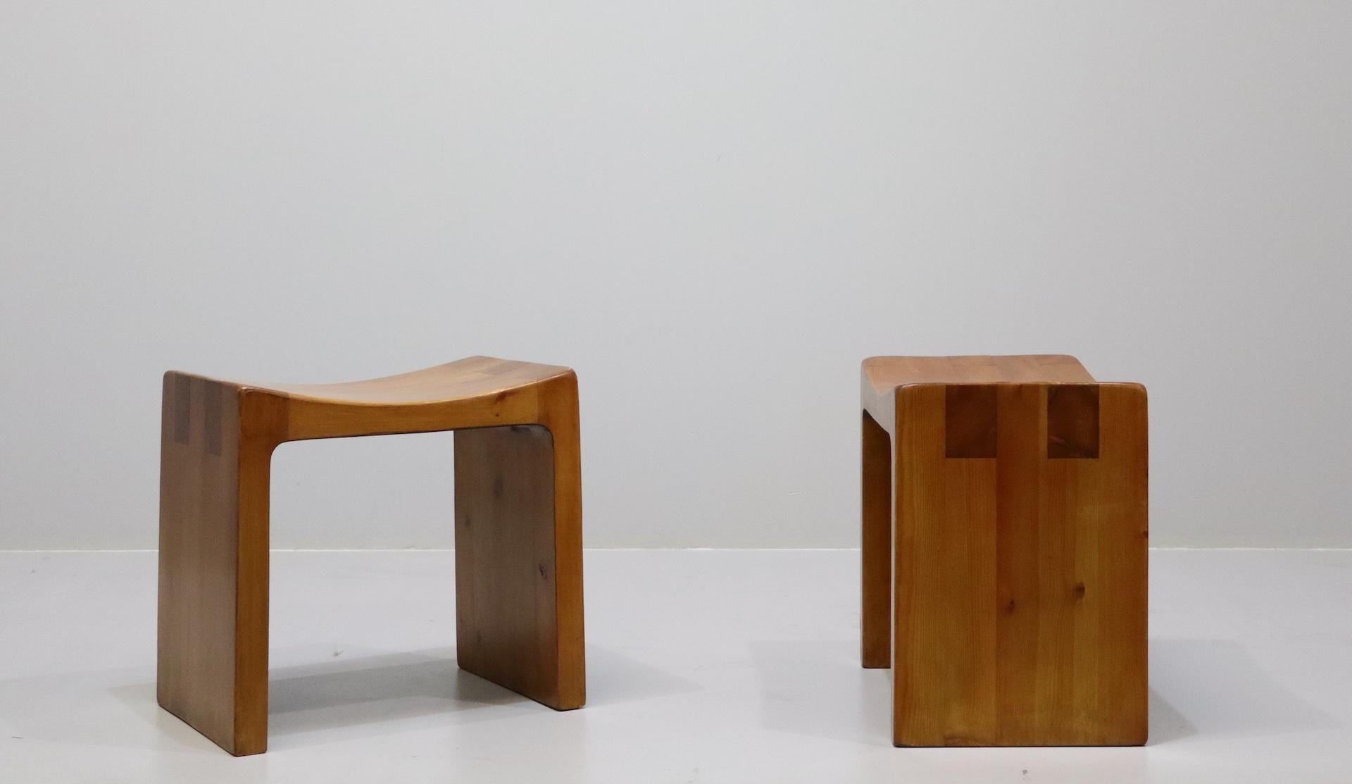 Rare pair of Italian stools by Giuseppe Rivadossi from the 1970s. The stools are made entirely of wood. Its construction is a perfect interlocking of noble wood inserts. Great mastery in woodworking.