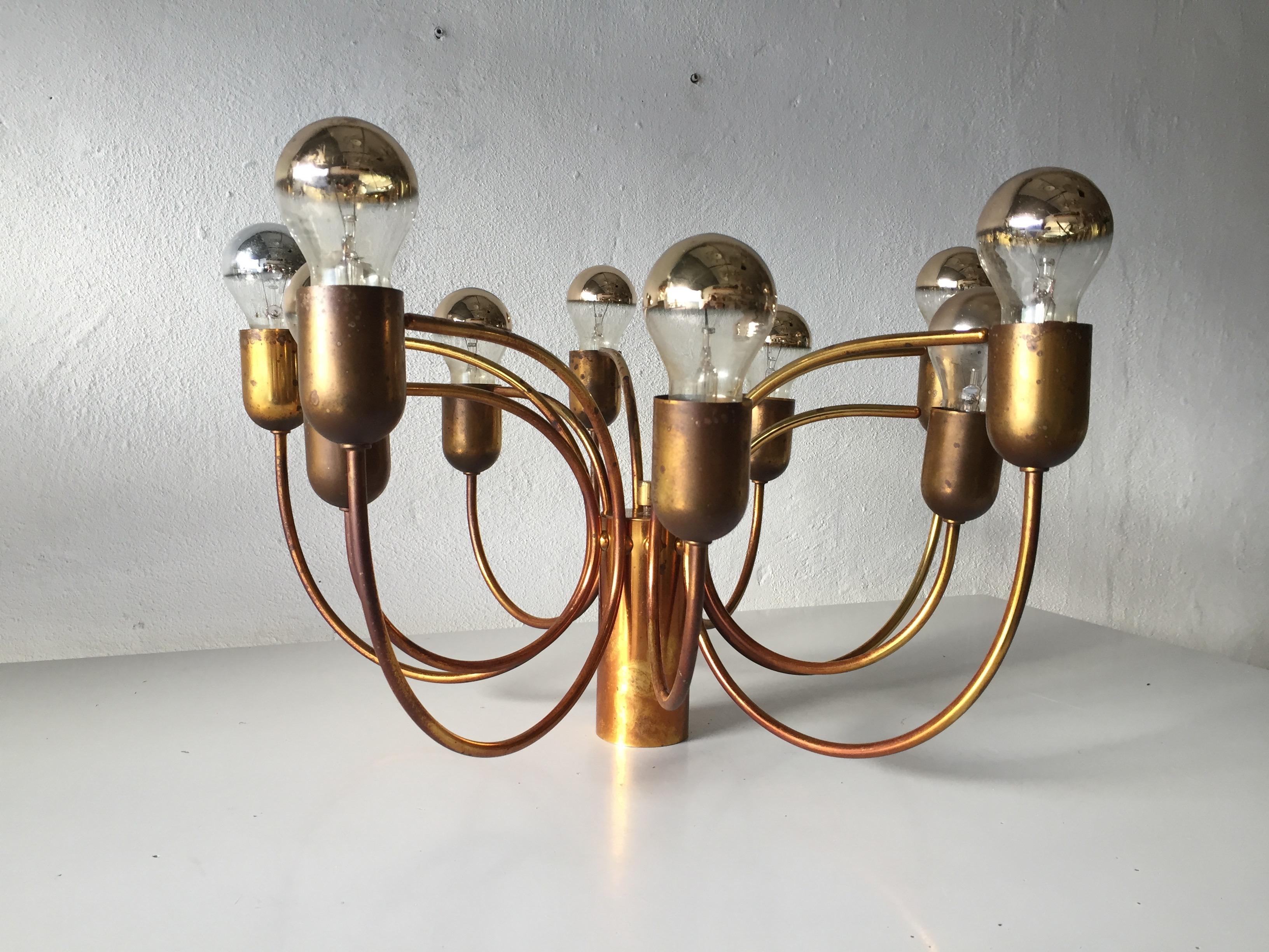 Rare 10 Arc Shaped Arms full brass chandelier by Cosack Leuchten, 1970s Germany

Pendant lamp with beautiful patina
Minimal design
Very high quality.
Fully functional.

Lamps are in very good vintage condition.
Wear consistent with age and