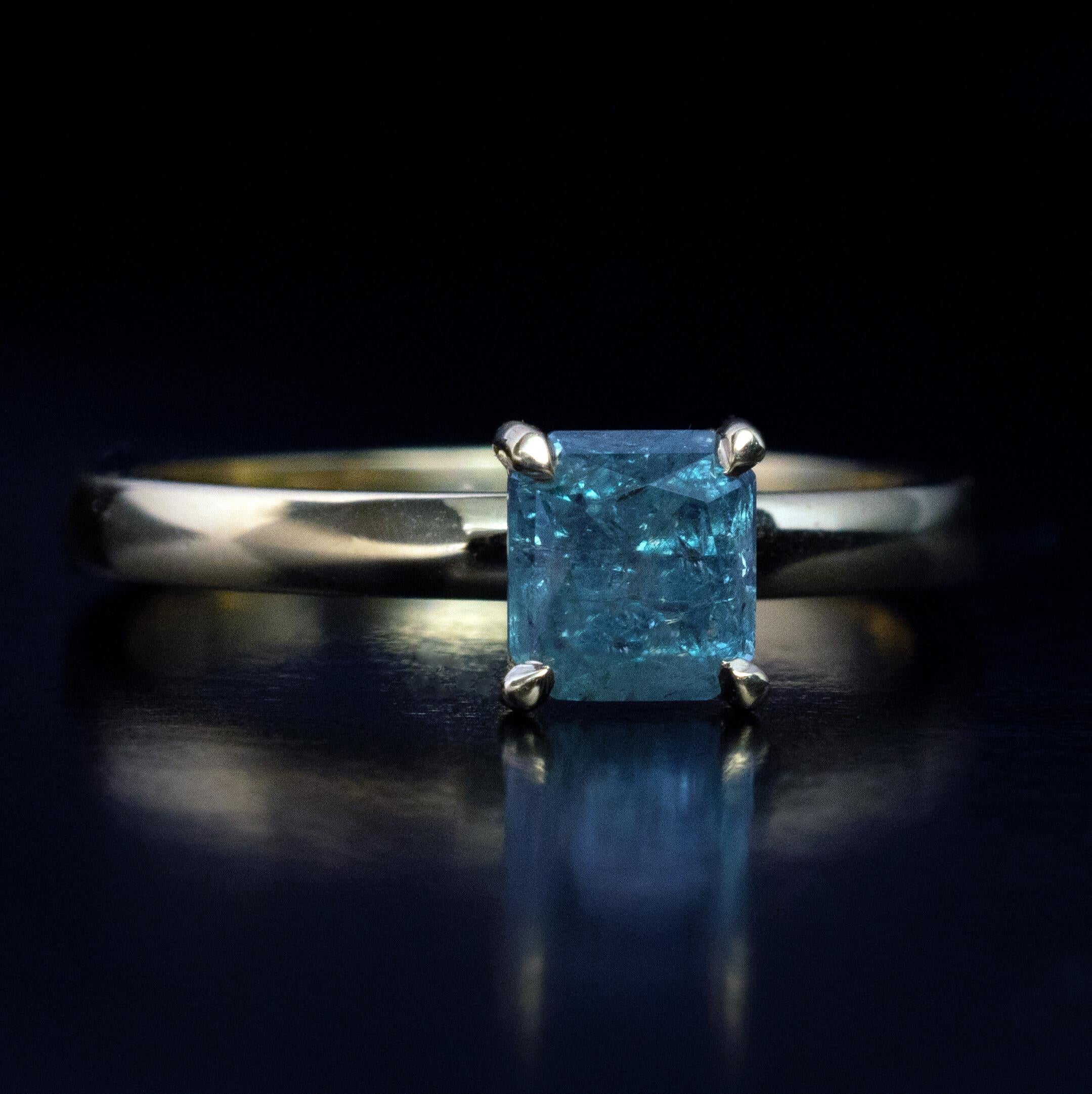This contemporary custom-made 18K gold engagement ring features a rare 1.11 carat octagon shape Russian Alexandrite.  The Alexandrite changes its color from bluish green (daylight) to light purple – pink (incandescent light). The color change is