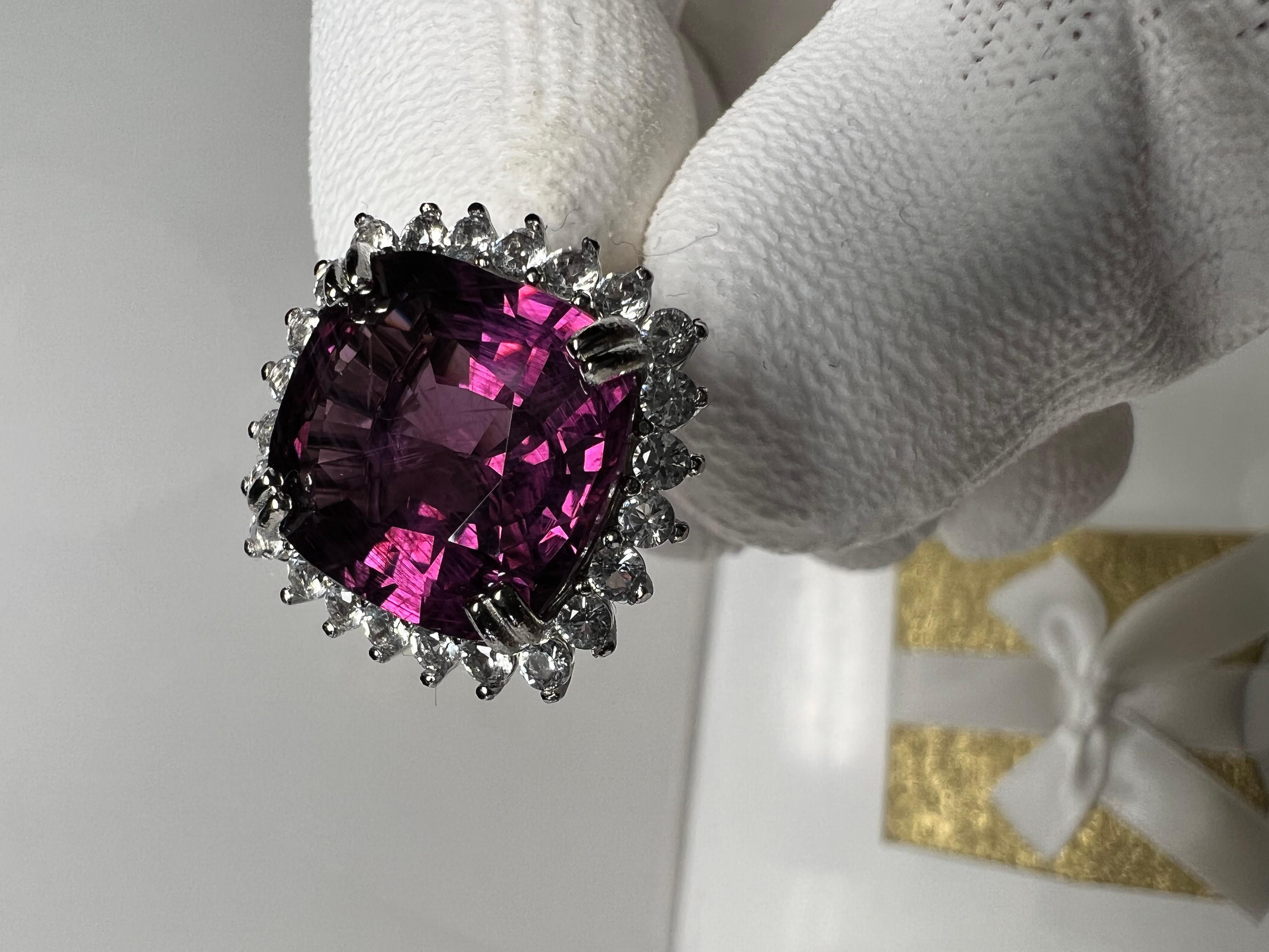 This beautiful GIA certified 11.81 Carat Pink Purple  Spinel is one of the once in a lifetime finds and opportunities a savvy collector and fine jewel lover can possess. It has been beautifully Preset in 925 Sterling Silver Ring with natural Topaz