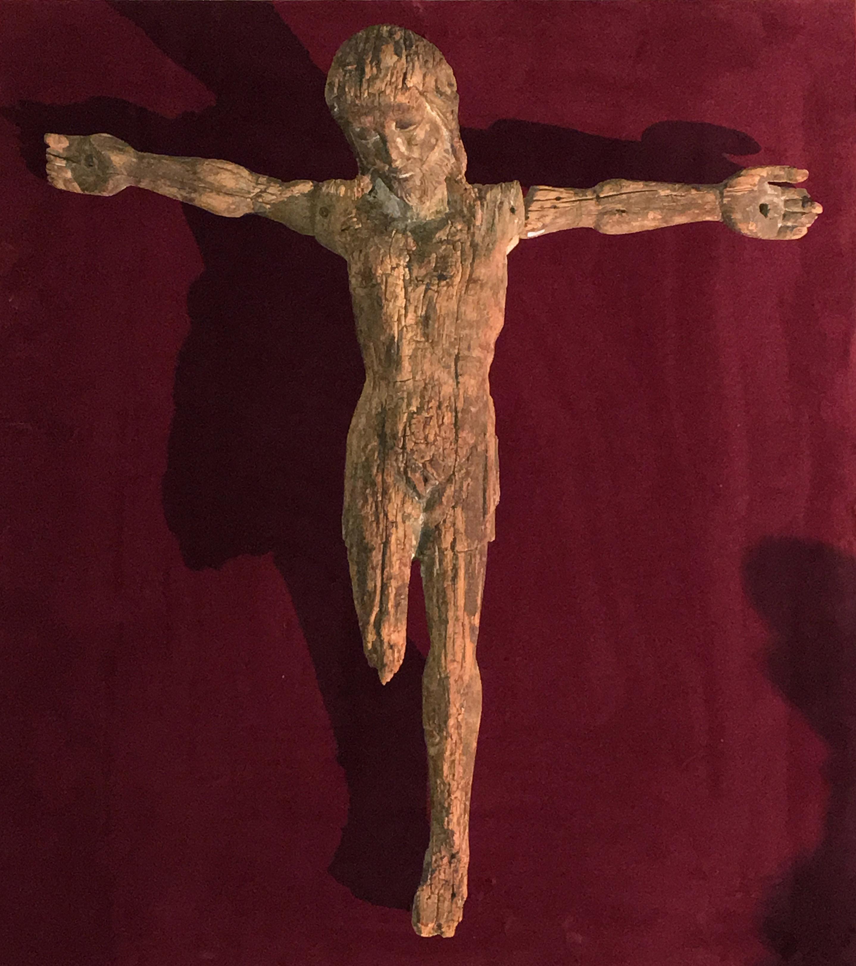 This wood Christ bears signs of time without diminishing its grace nor its interest.

This Christ presents some characteristic of the previous century. While the feet are missing the position of his legs, parallel one to the other, let us think