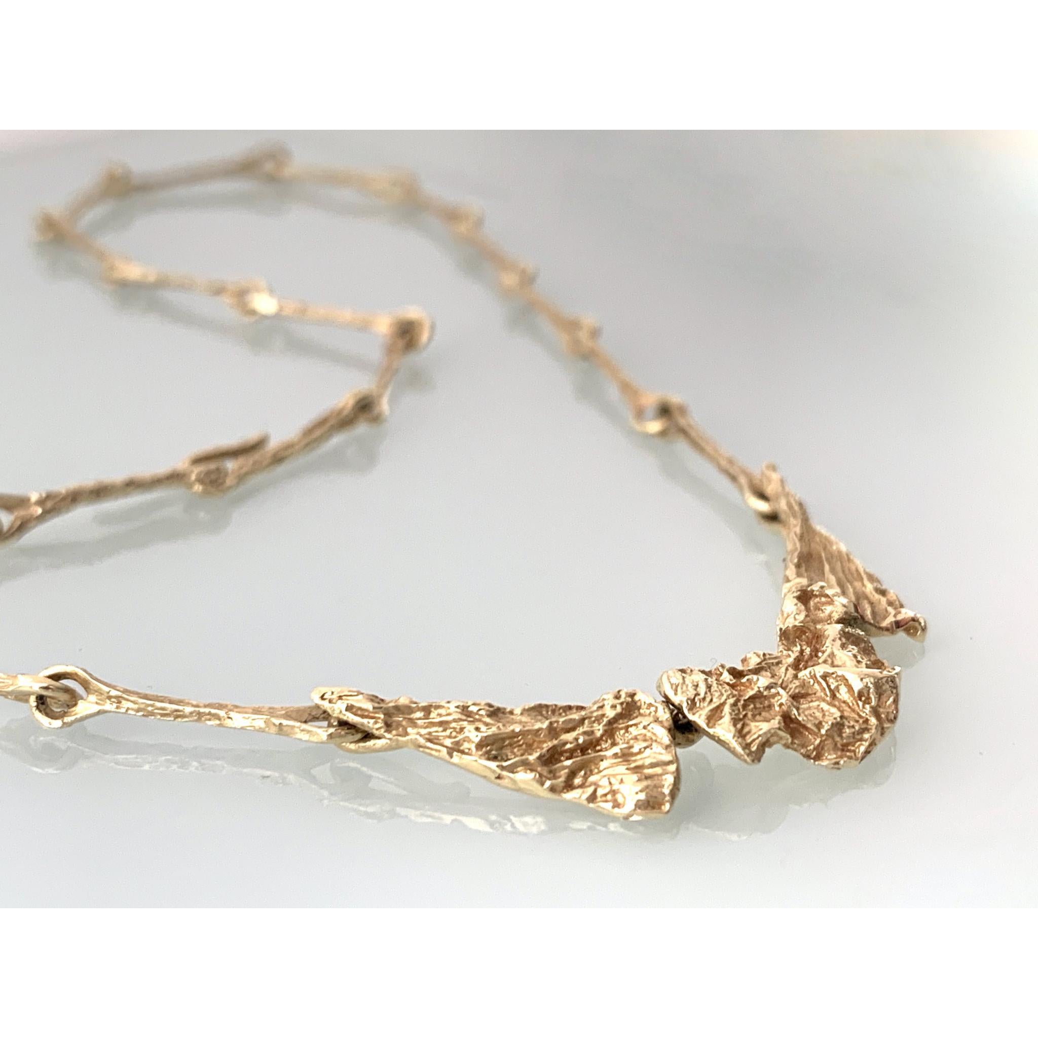Rare 14 carat Gold Brutalist necklace 
by Danish Designer Harry Askel Norgaard
Stamped HAN 585
Segmented front section depicting a naturally formed surface
lead by long links in a complementing design 
that has strong hook fastening of continuation