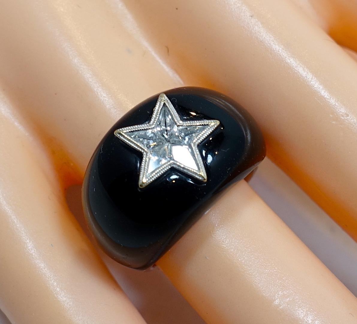 As soon as I saw this ring, I knew it was a rare piece, featuring a center diamond star in onyx on a 14kt white gold setting.  A size 6, this ring measures 1/2” wide and is in excellent condition.