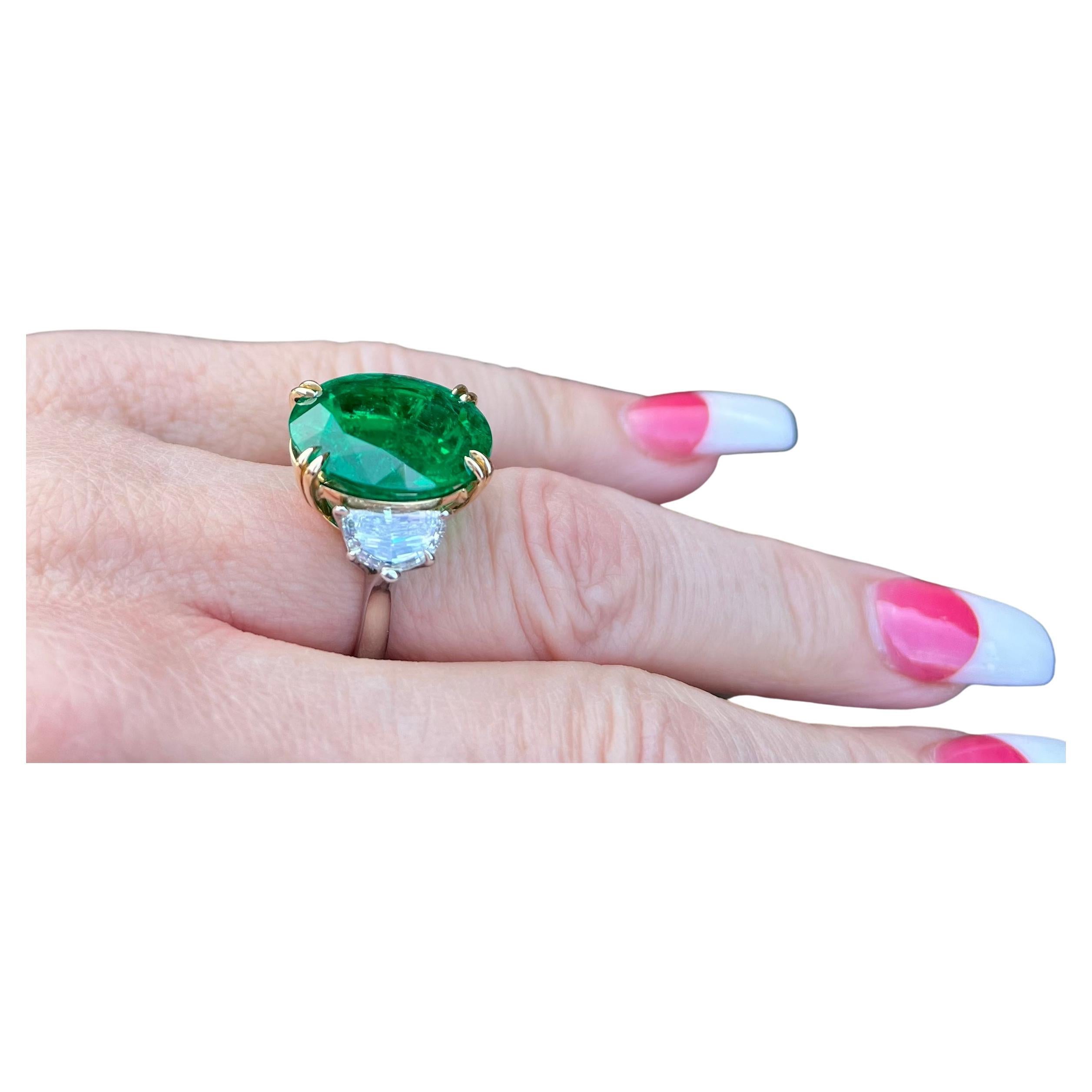Incredible and very noteworthy, 16.04 carat estate AGL Certified huge oval modified brilliant cut Columbian Emerald and Diamond Ring is set in 18 karat white and yellow gold. This is the most incredible emerald and diamond ring I have ever laid my