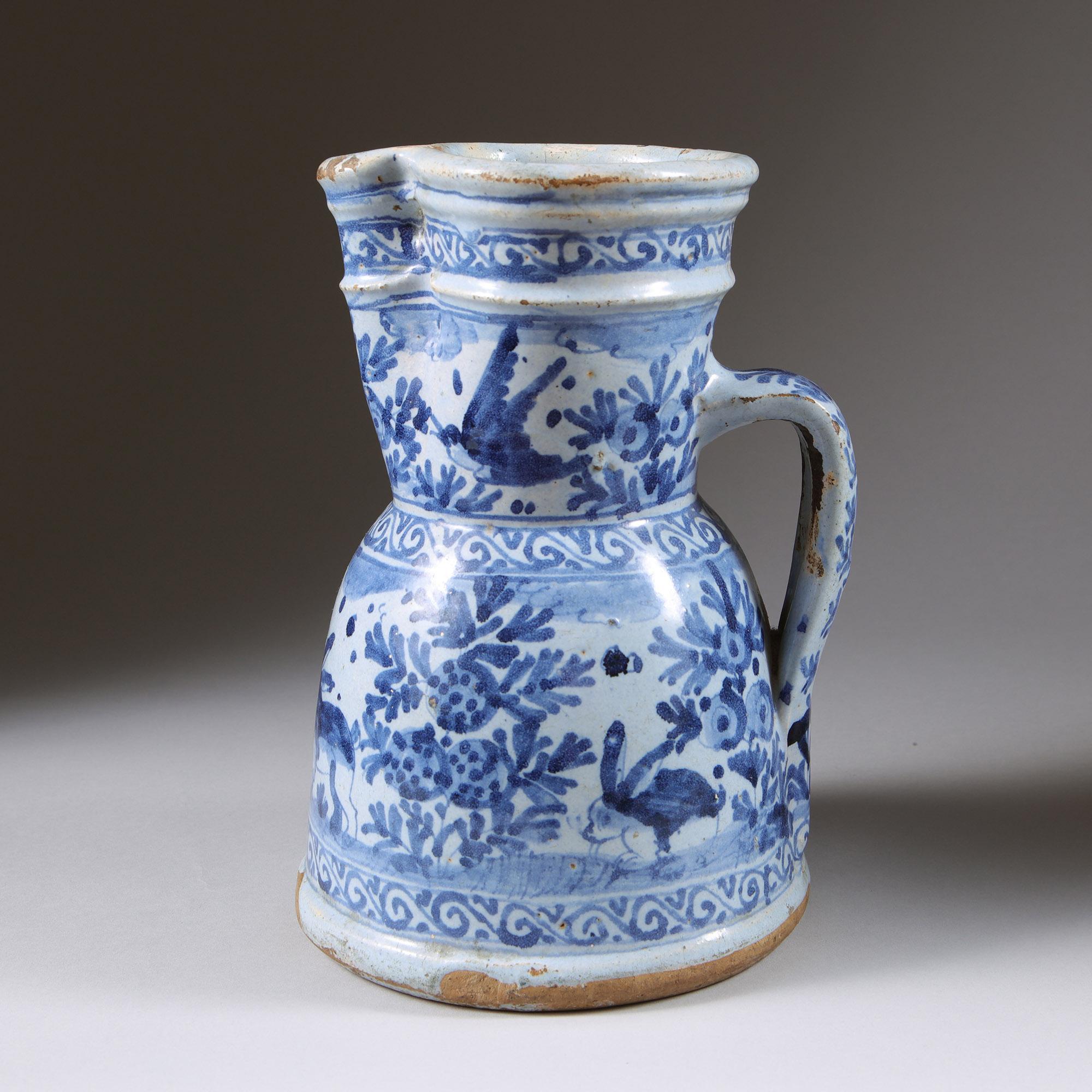 A Rare and Highly Attractive Late 17th/Early 18th Century Delft Jug with Loop Handle. Circa 1690-1710

The body painted in a naive manner with medallions of three country rabbits within scrolling flora and foliage motifs and flying birds above.