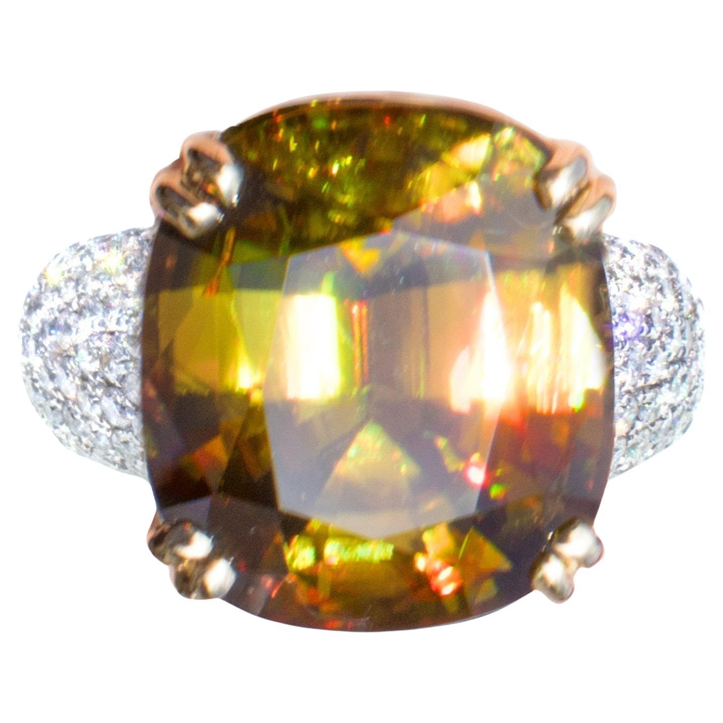 Sophistication Unveiled:

Behold this resplendent cocktail ring, a true masterpiece meticulously crafted in solid 18K yellow gold. At its heart lies a magnificent fancy cushion-cut AAA Sphene gemstone, adorned with an array of colorless, pave-set