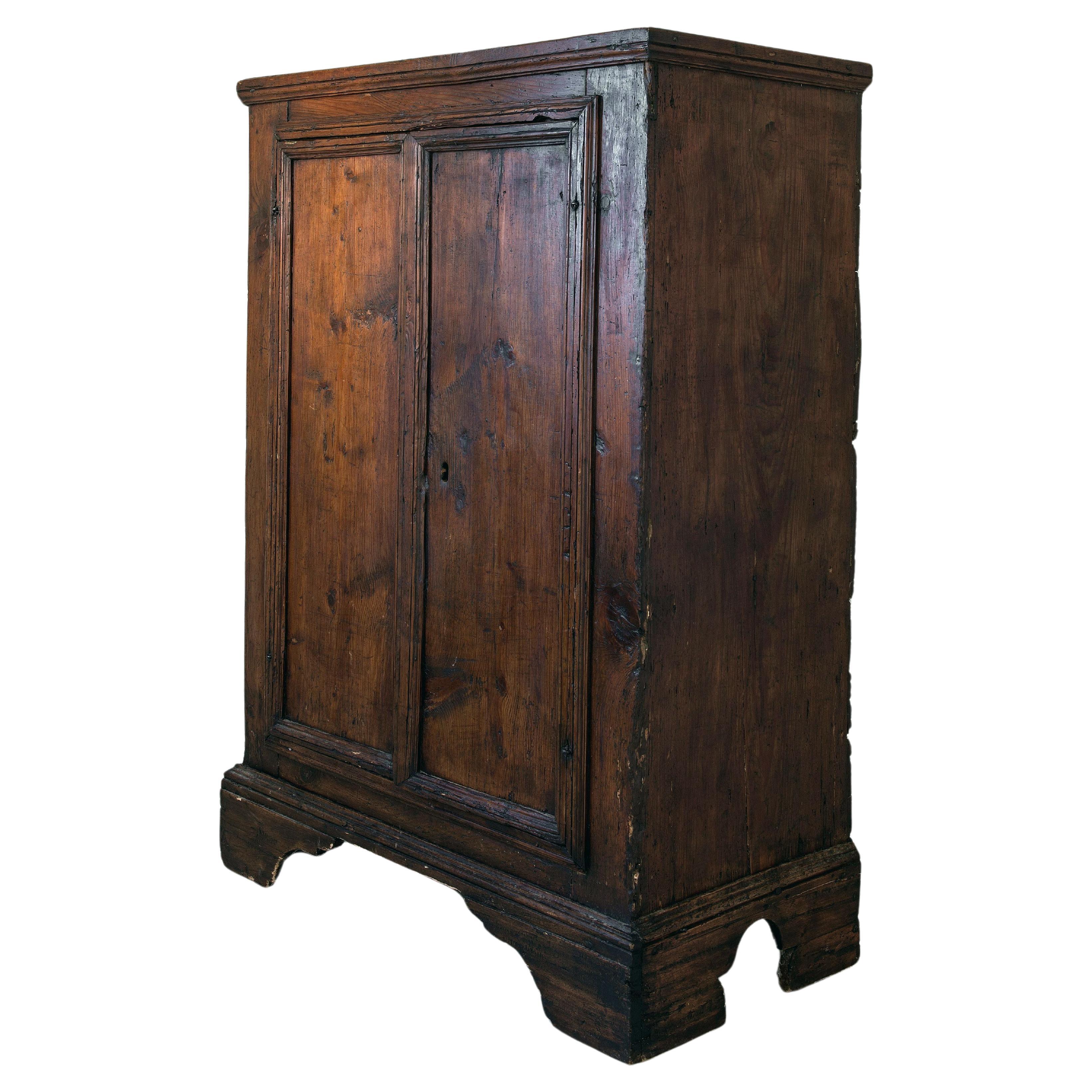 An exceptional late 17th, early 18th century cabinet in a beautifully patinated chestnut, old, possibly original forged lock.  Very good condition.

This sculptural piece would work in most settings because of its unusual proportions- It can be used