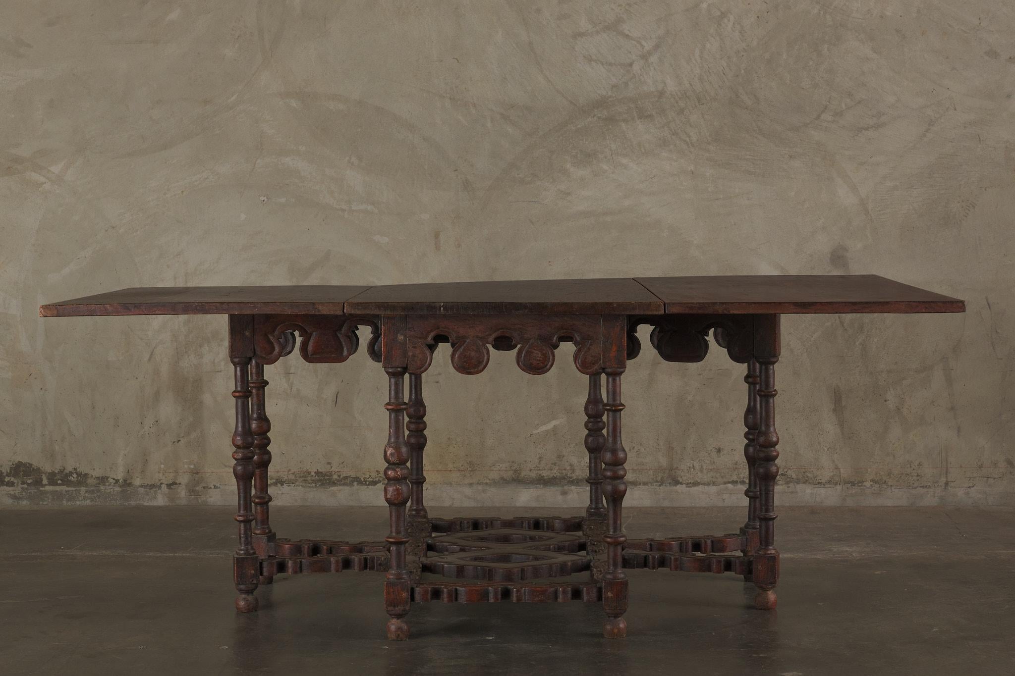 It is a very rare to find a 17th century table in such good shape. This handsome Italian folding center table is supported with eight richly carved legs and is extendable from 34