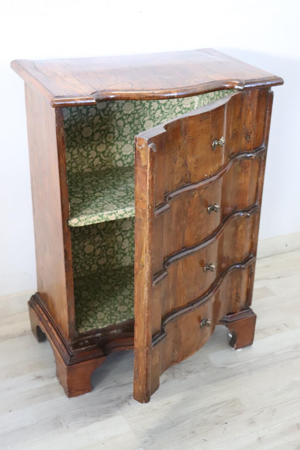 Rare and fine quality Italian Venetian 1680 antique nightstand in walnut veneer. The veneering of the wood is very thick as was used in ancient times. Particular wavy shape on the front typical of Venetian furniture. It might appear to have drawers