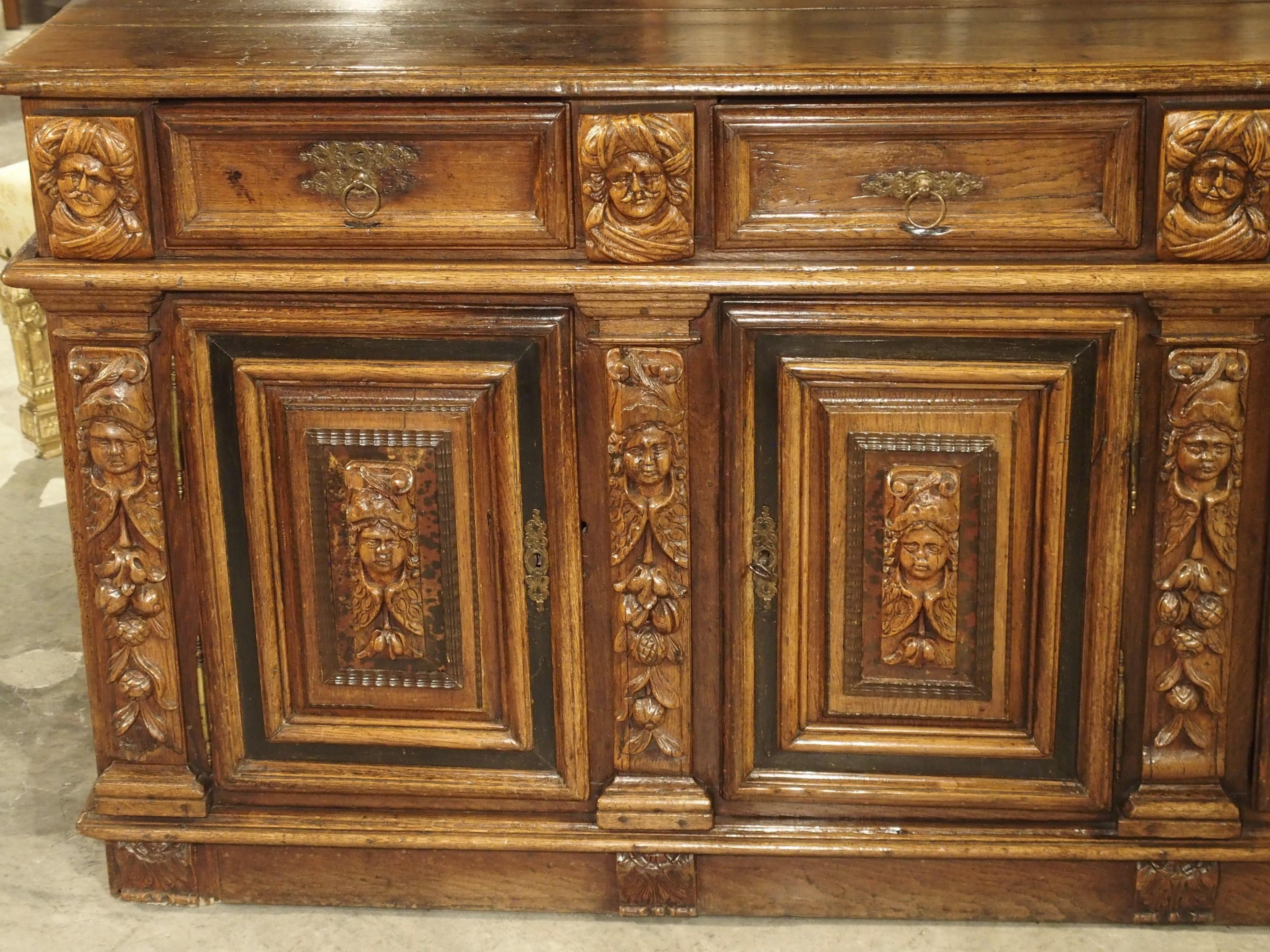 This beautiful and rare three door enfilade buffet comes from northern Europe, most likely the Netherlands or Flanders. This type of furniture can also be called a Dresche. Along the back of the top, is a thin groove for displaying fine plates