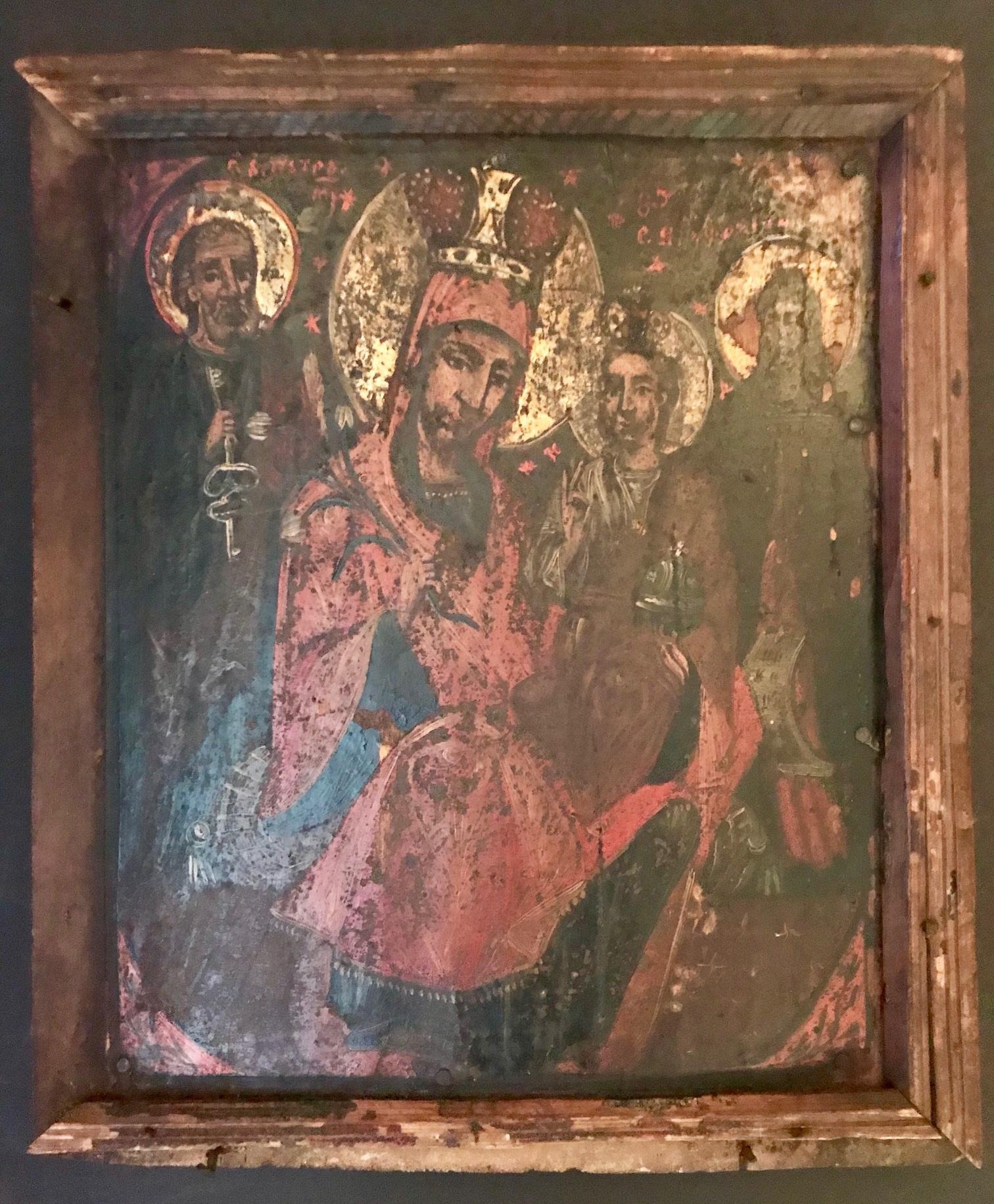 This exceptional icon was created the late 1600s in Russia. Icons are considered to be gospel in paint. This one depicts four saints. It is painted with egg tempera on a wood panel, which has warped only slightly with age. Soot from burning candles