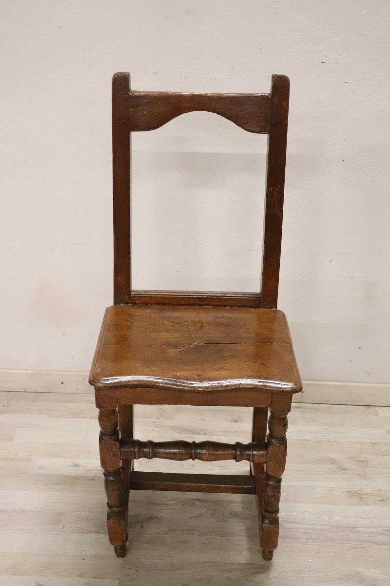 Beautiful 17th century of the period Louis XIV Italian antique rustic chair in solid walnut wood. The chair is very simple and essential. The legs are finely turned. The seat is rustic in wood but made comfortable by a custom-made cushion. The chair