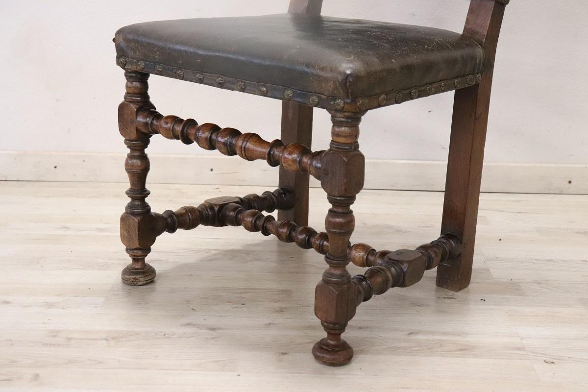 Beautiful 17th century of the period Louis XIV Italian antique chair in solid walnut wood. The legs are finely turned. Seat and backrest are padded and covered in leather. This type of chairs was intended for important and rich environments such as