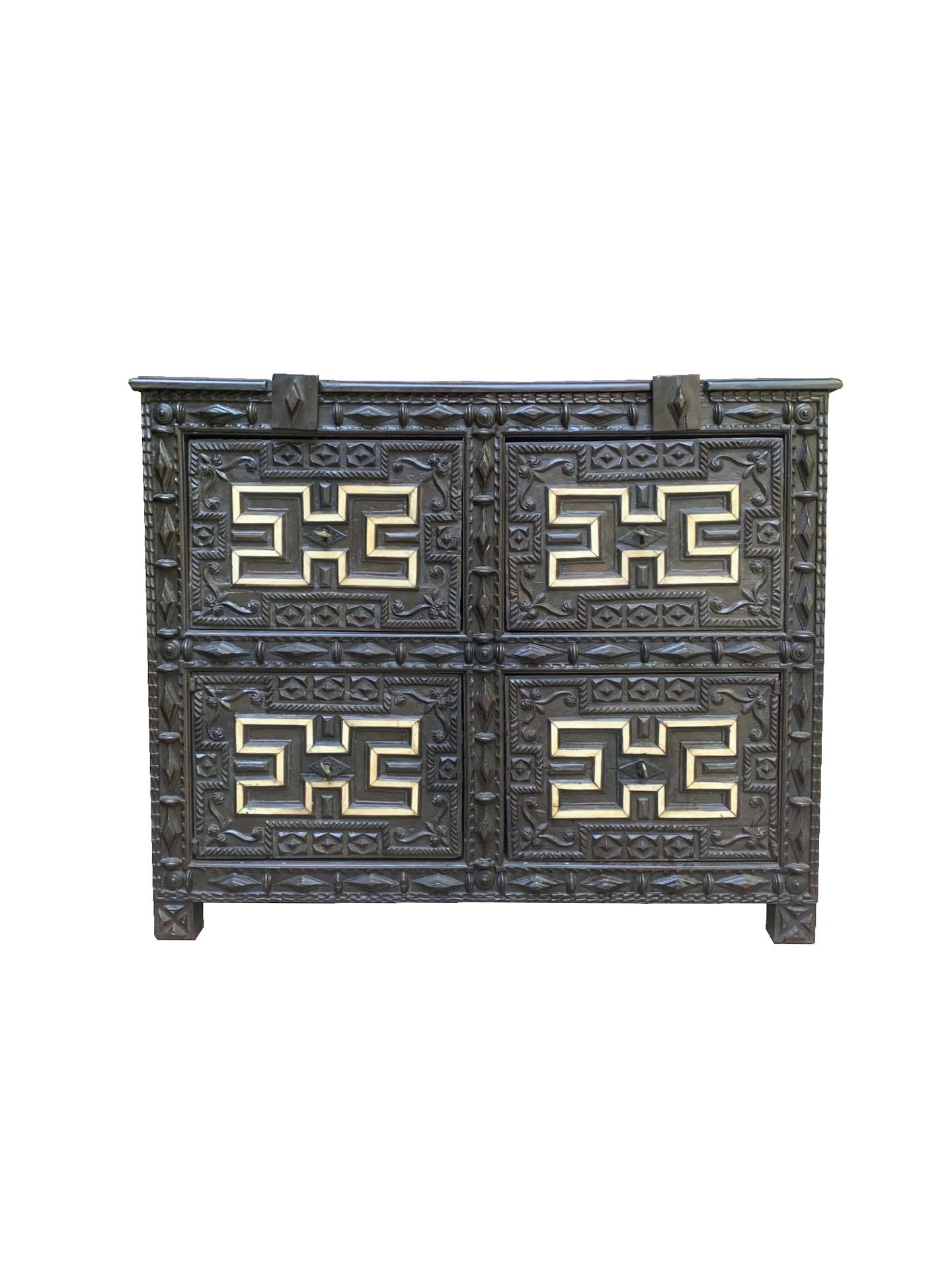 An exquisite Spanish Colonial 17th Century Taquillón, a piece that epitomizes the craftsmanship and artistic sensibility of the Spanish Baroque period. This beautifully carved chest, dating back to around 1650-1700, was traditionally used for