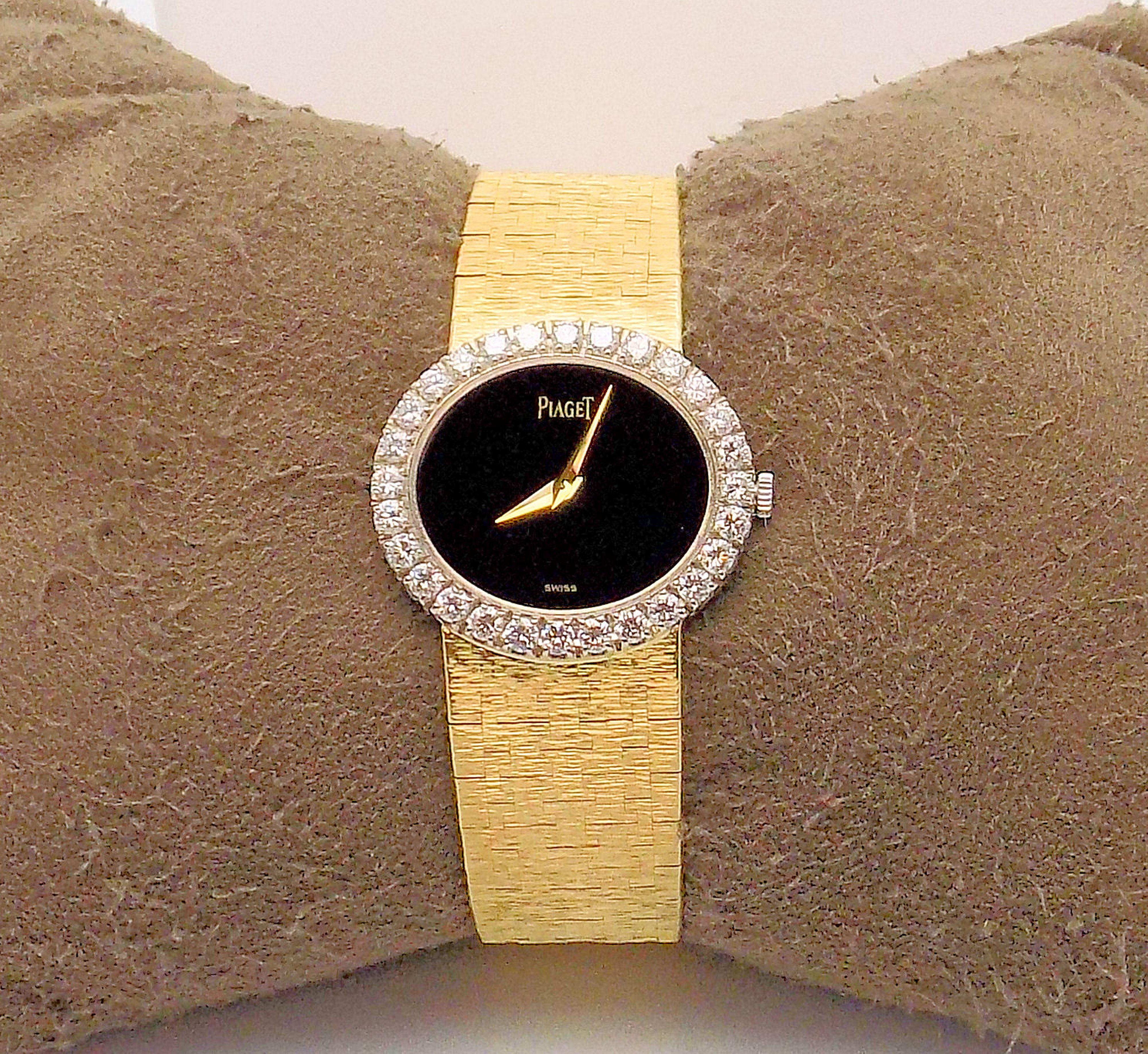 Exquisite 18 Karat Yellow Gold Lady's Stone Dial Piaget Wrist Watch; Jewel Movement; Black Onyx Dial and Restoration by Piaget; Case: 26 X 24 MM; 28 Round Brilliant Diamonds 2.00 Carat Total Weight; VVS-2, F; P-9 Textured Tapered Bracelet;  6 3/ 8”