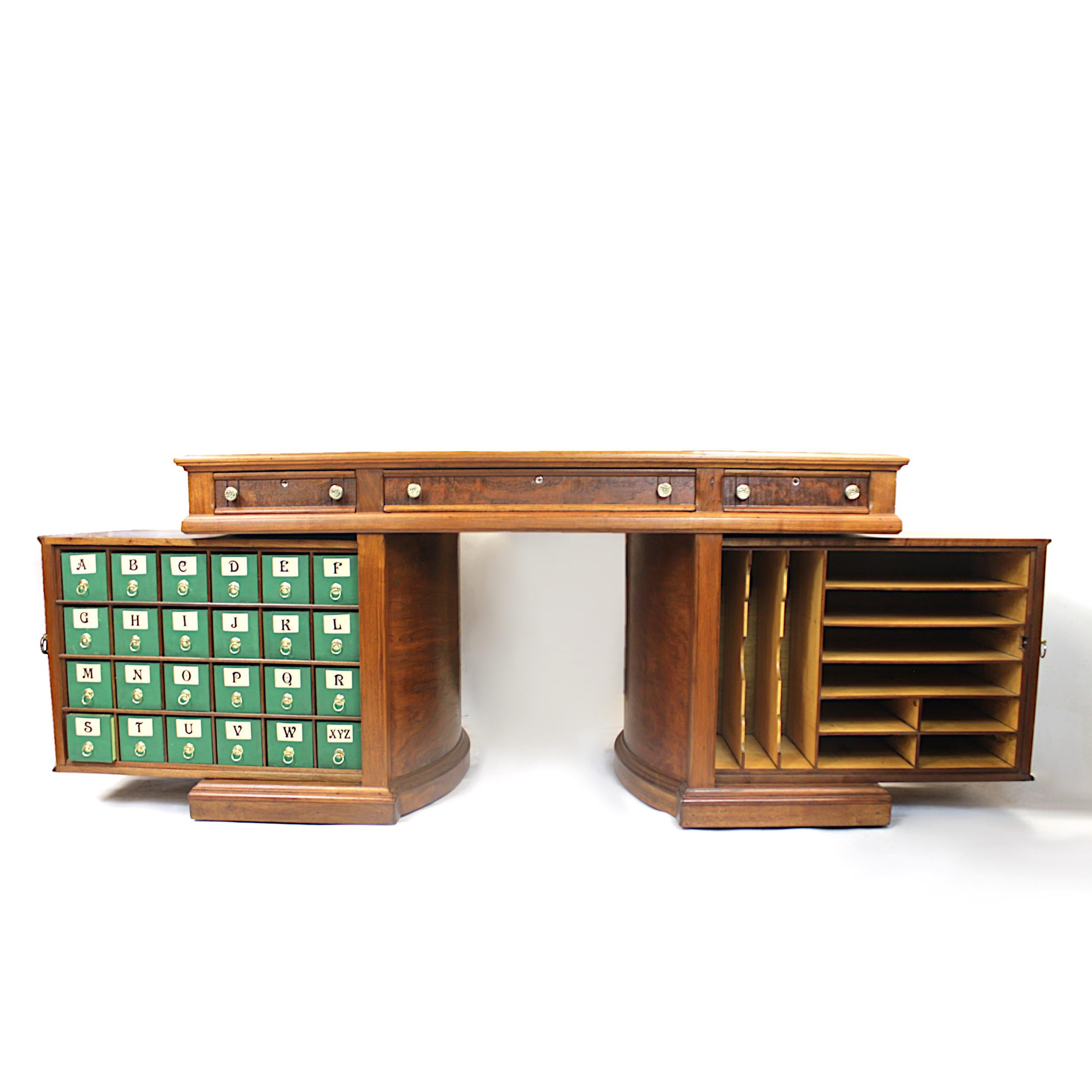 This is a rare model No. 8 Rotary desk in the Queen Anne style made by the Wooton Desk Manufacturing Co. of Indianapolis Indiana. Desk features solid, burled walnut construction, leather, top, brass hardware, and those unique, Wooton rotating cases!