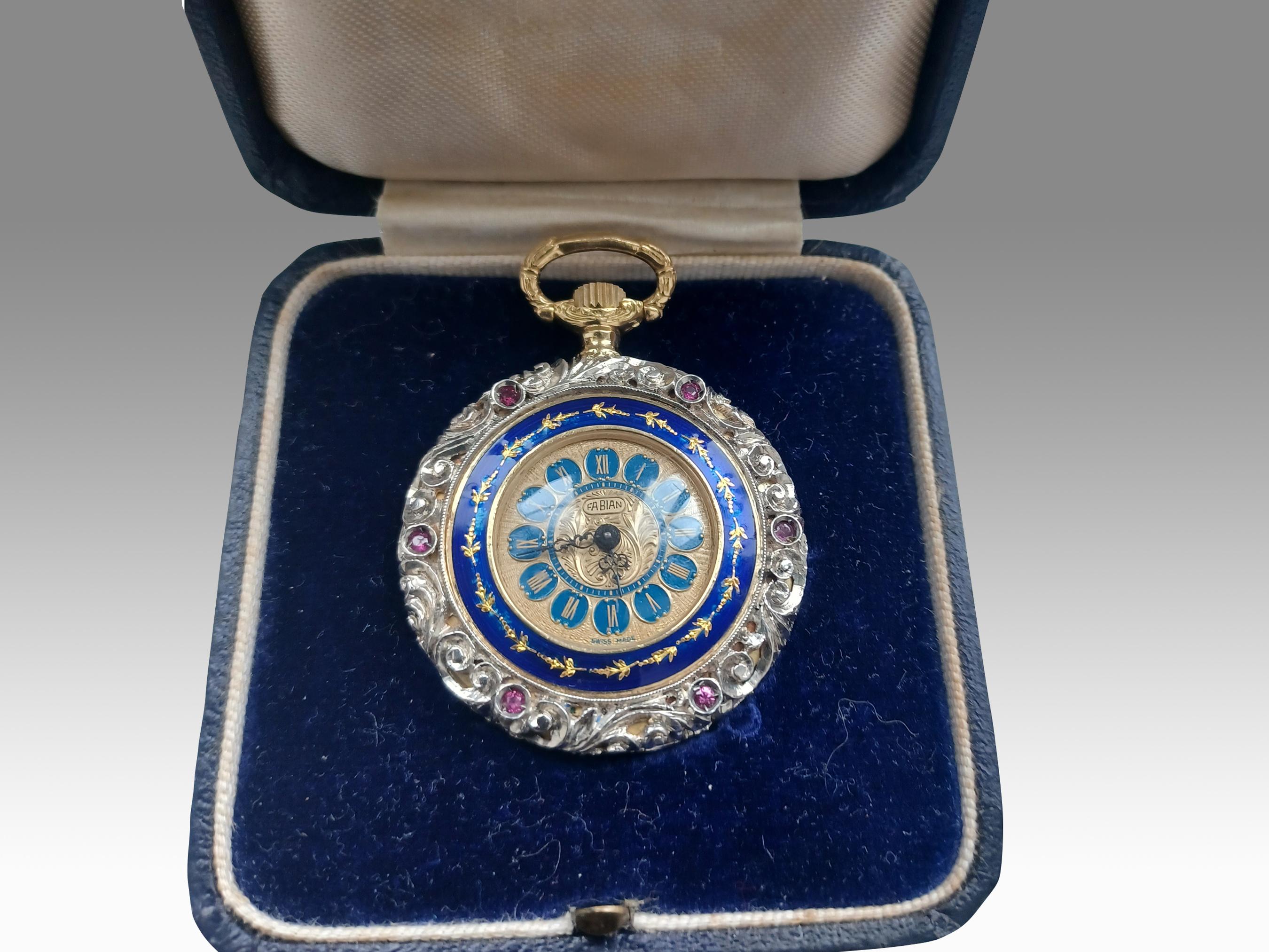 
While the origin of this particularly unique piece remains a mystery, the brilliance and fine craftsmanship are without question. This small 18ct jewellery pocket watch houses elaborate, decorative silver mounting and bezels. There are 6 rubies at