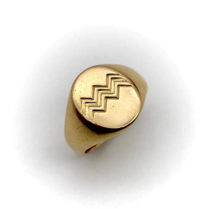 This 18k gold signet ring is designed by French Art Deco artist and jewelry maker Jean Després.  At first glance, it is a classic signet ring engraved with simplistic geometric patterns. But with a closer look, the pattern represents water. Després