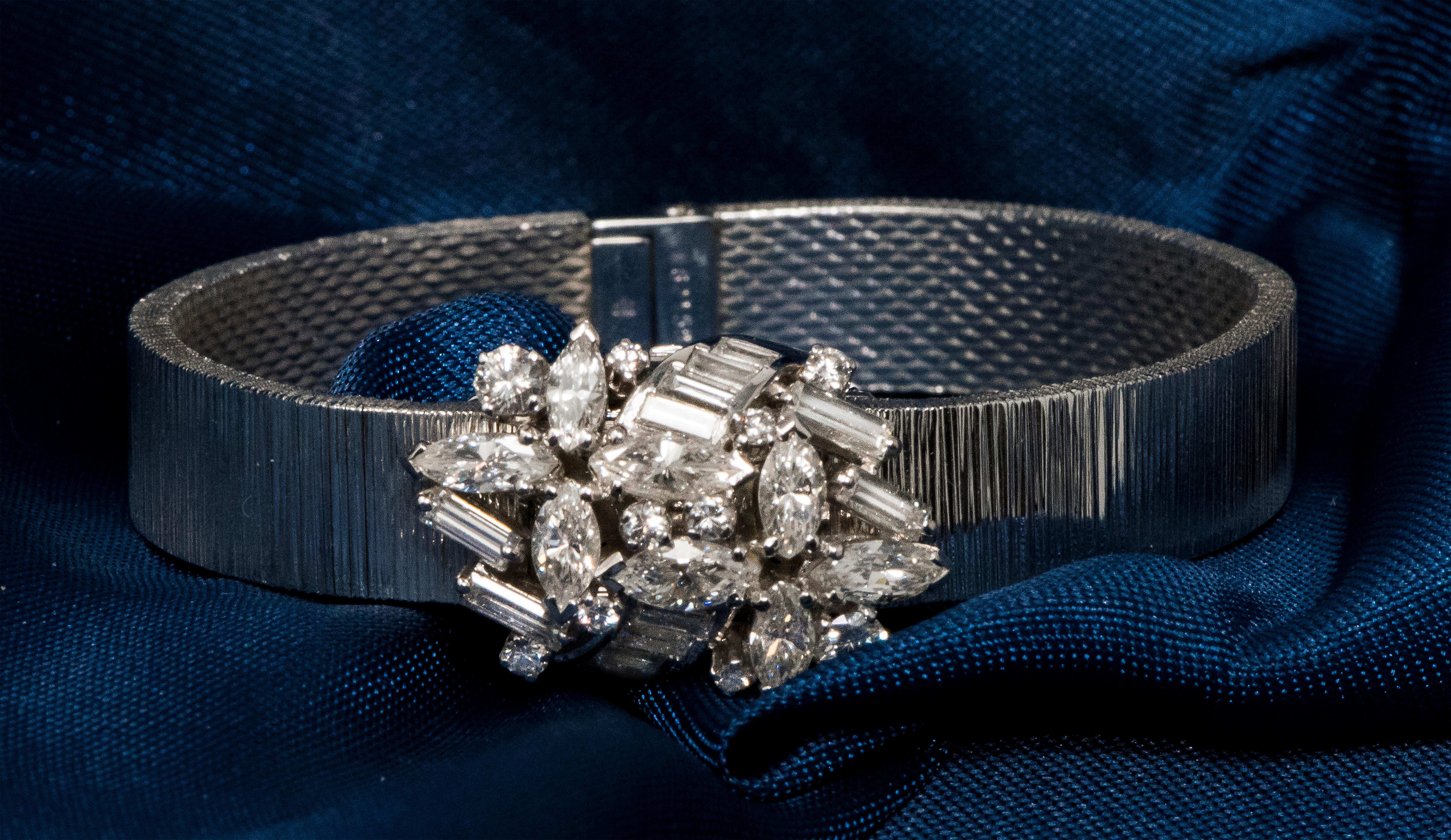 A Rare Specially designed  1950s Omega 18kt White Gold Double Marquis & Emerald Cut Diamond Set Wild Flower Corsage Style Concealed Bracelet Watch

Basic Specifications & Special Features

- Case Dimensions:
- 16mm wide across diamond cover X 25mm