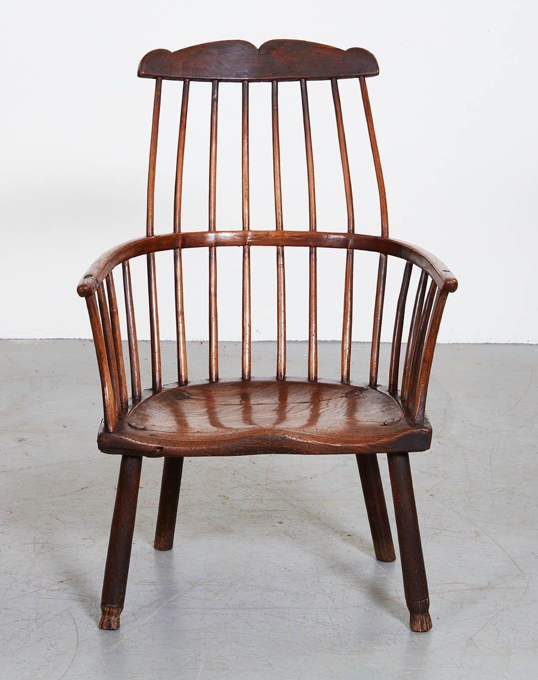 Very good English lobster pot Windsor chair, having shaped crest over shaved spindles with bent yew wood continuous arm over deeply saddled elm seat and standing on pole lathe turned legs, bearing owner's brand 