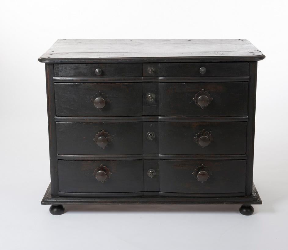 This extraordinary 18th century ebonized baroque commode with a writing drawer was made in Spain, circa 1760.
18th century baroque period four-drawer painted pine chest with a slightly serpentine front and ball feet in the front.
The small writing
