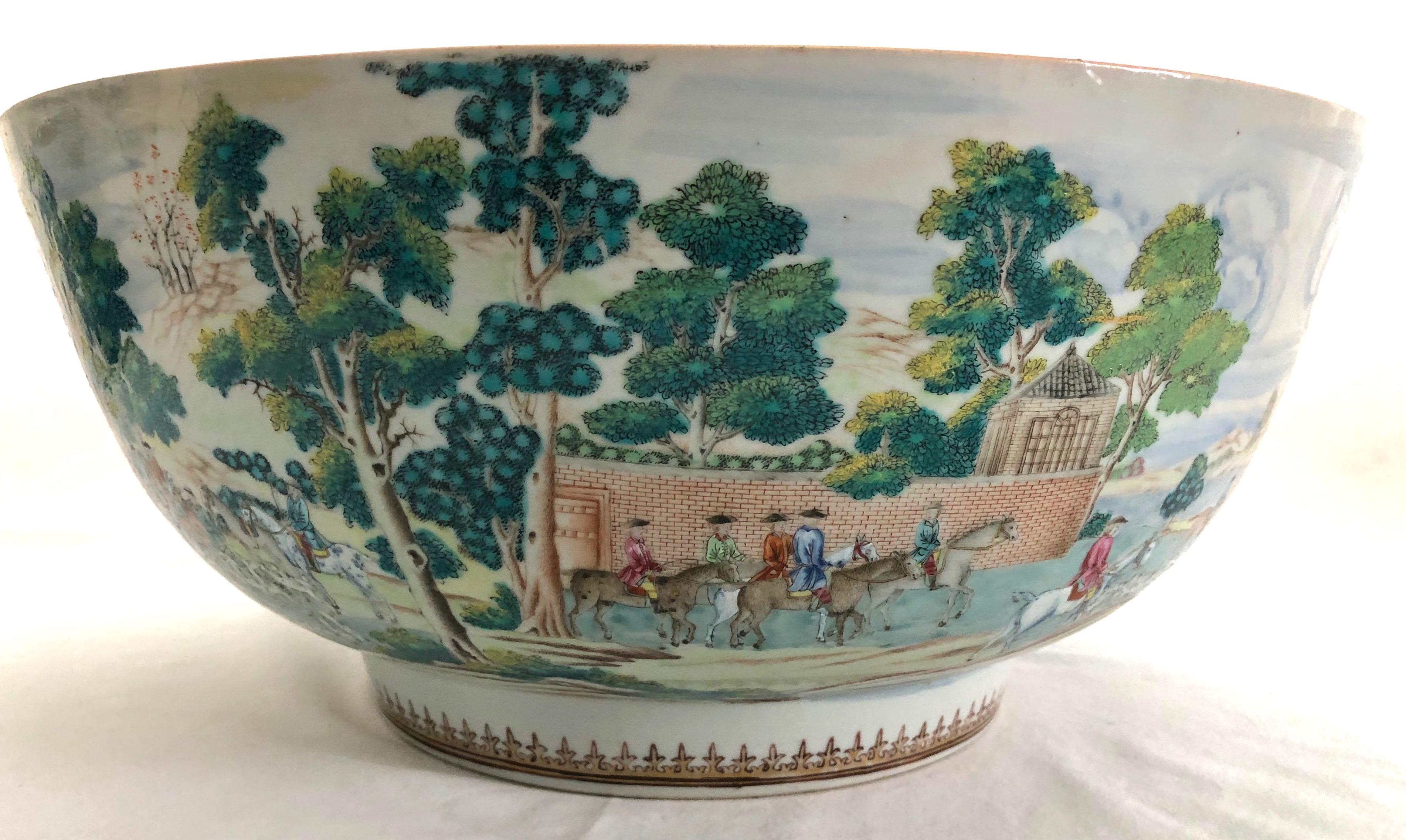 A very fine and rare Chinese export large porcelain punch bowl with extremely detailed, continuous english fox hunt scenic decoration. The interior having a gilt swag rim border above a central English horse and rider pictorial, all resting on a rim