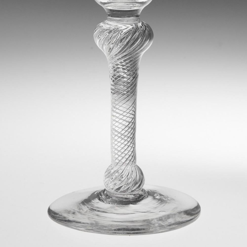 Heading : An18th Century Double Knop Multi Spiral Air Twist Wine Glass
Period : George II
Origin : England
Colour : Clear, pale grey-blue hue
Bowl : Round funnel. Good pucelal marks
Stem : Multi spiral air twist with inverted baluster knop and