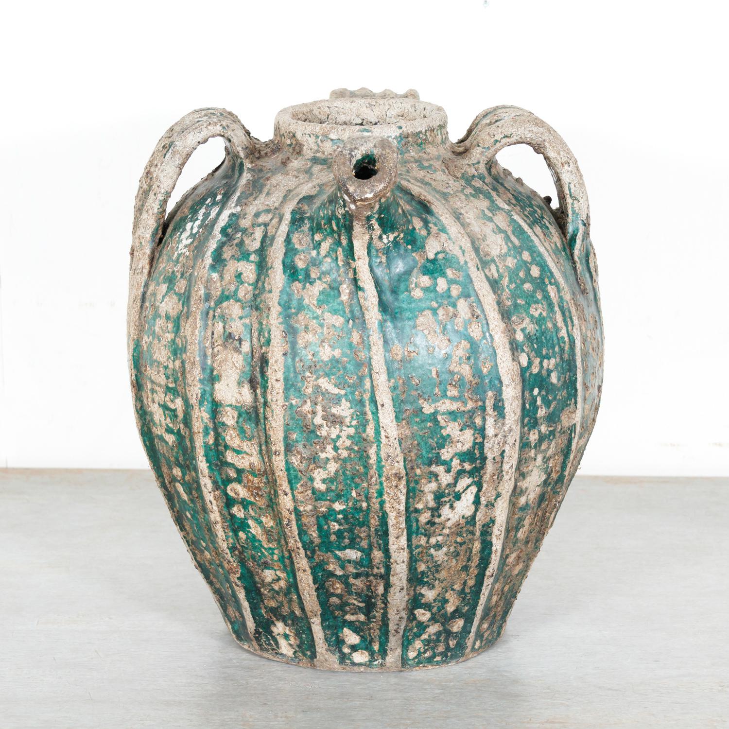 A large 18th century French glazed terracotta cruche du Quercy or walnut oil jug having great sculptural form and artisan quality, handmade by a talented potter in Quercy, a former province in southwest France, circa mid 1700s. This rare glazed