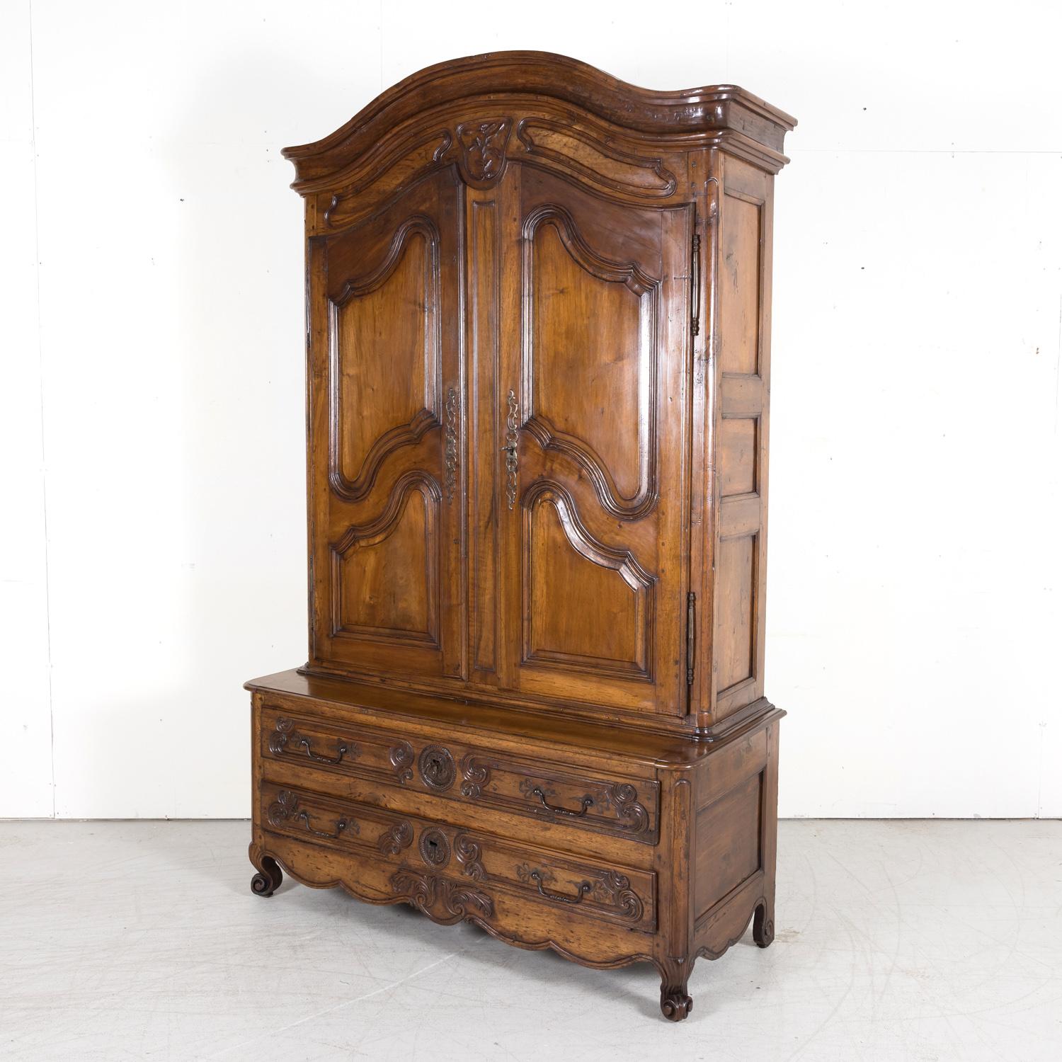 18th century French Louis XV period armoire deux corps pantalonnier handcrafted of old growth French walnut by skilled artisans in the South of France near Aix-en-Provence, circa 1750s. Similar to a linen press, this rare two-piece cabinet features